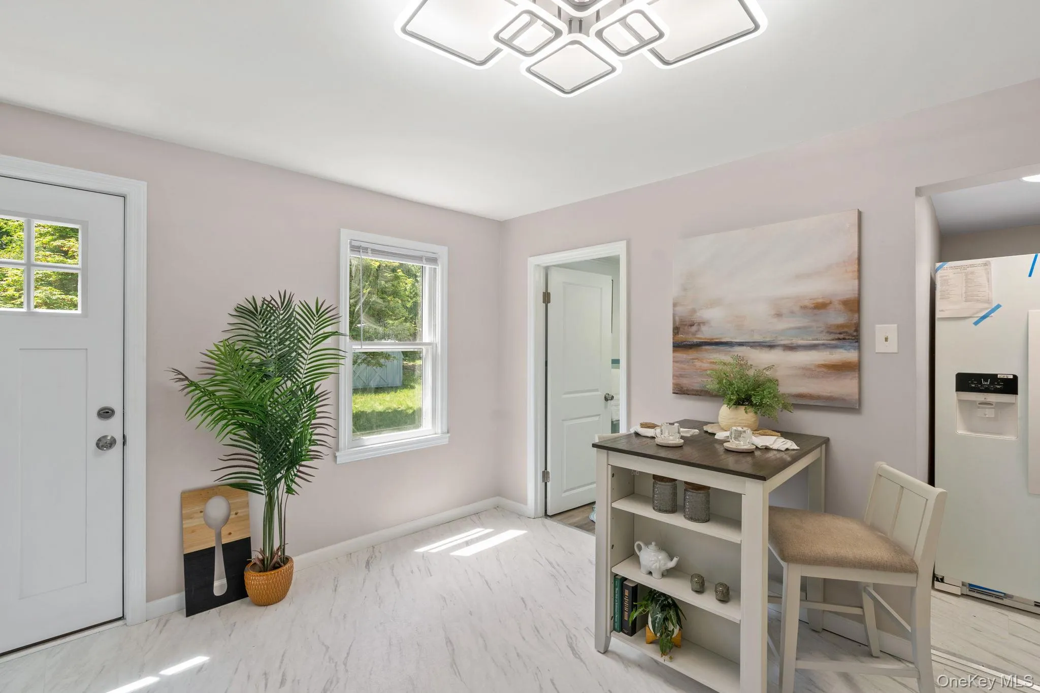 Foyer entrance featuring marble finish floors and baseboards Foyer entrance featuring marble finish floors and baseboards