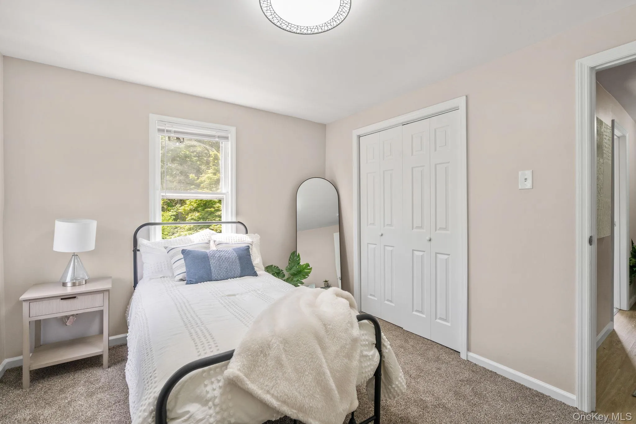 Bedroom featuring carpet and a closet Bedroom featuring carpet and a closet