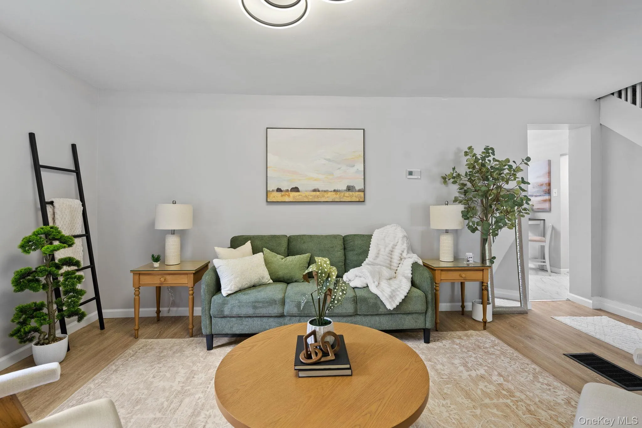 Living area featuring wood finished floors and baseboards Living area featuring wood finished floors and baseboards