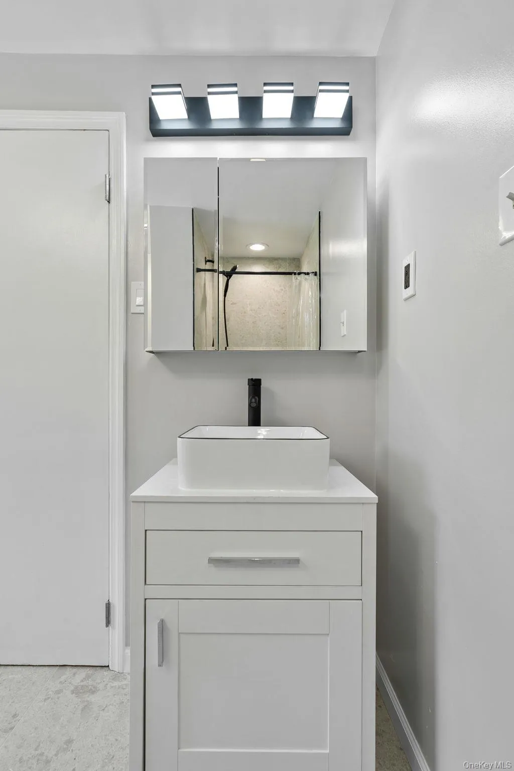 Full bathroom with vanity and curtained shower Full bathroom with vanity and curtained shower