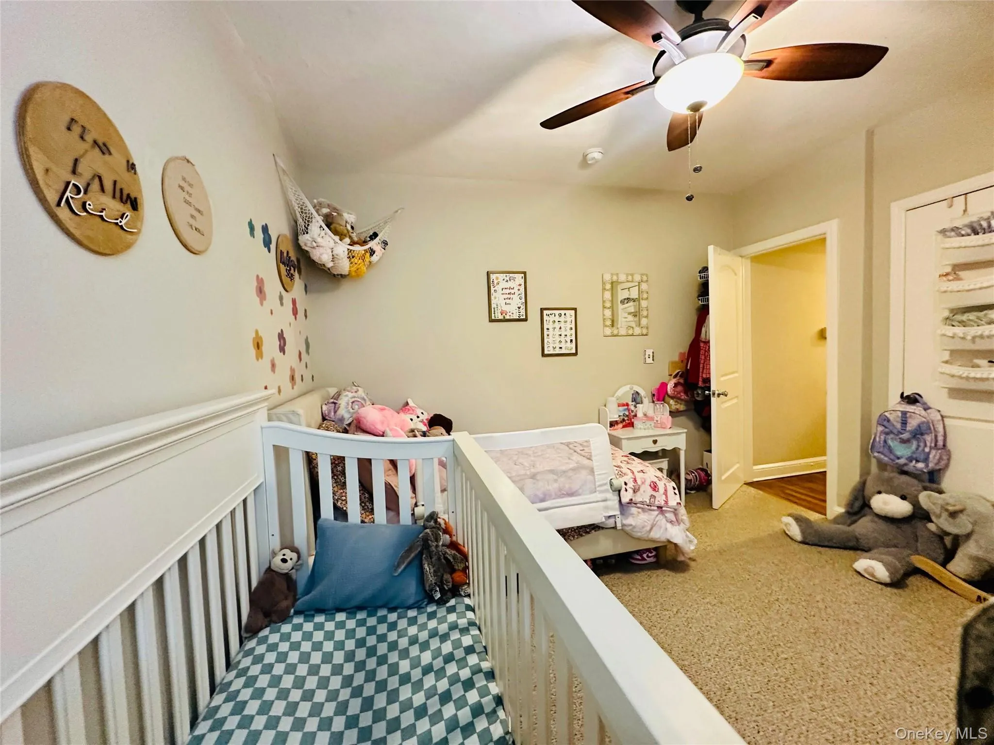Bedroom with a ceiling fan and a nursery area Bedroom with a ceiling fan and a nursery area