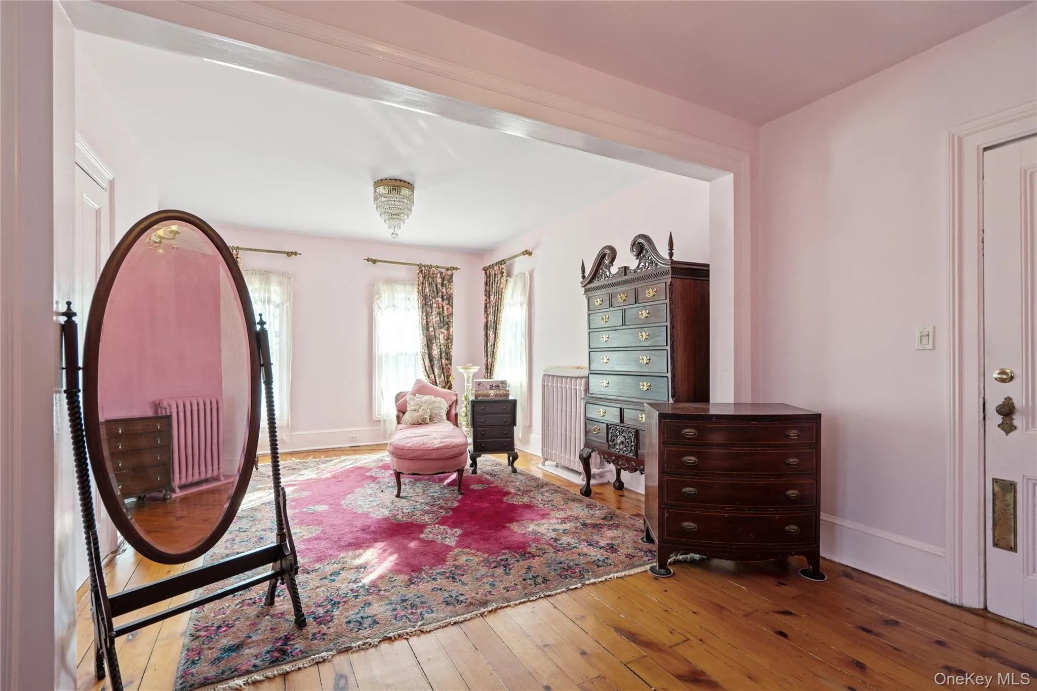 Bedroom with hardwood / wood-style flooring and radiator Bedroom with hardwood / wood-style flooring and radiator