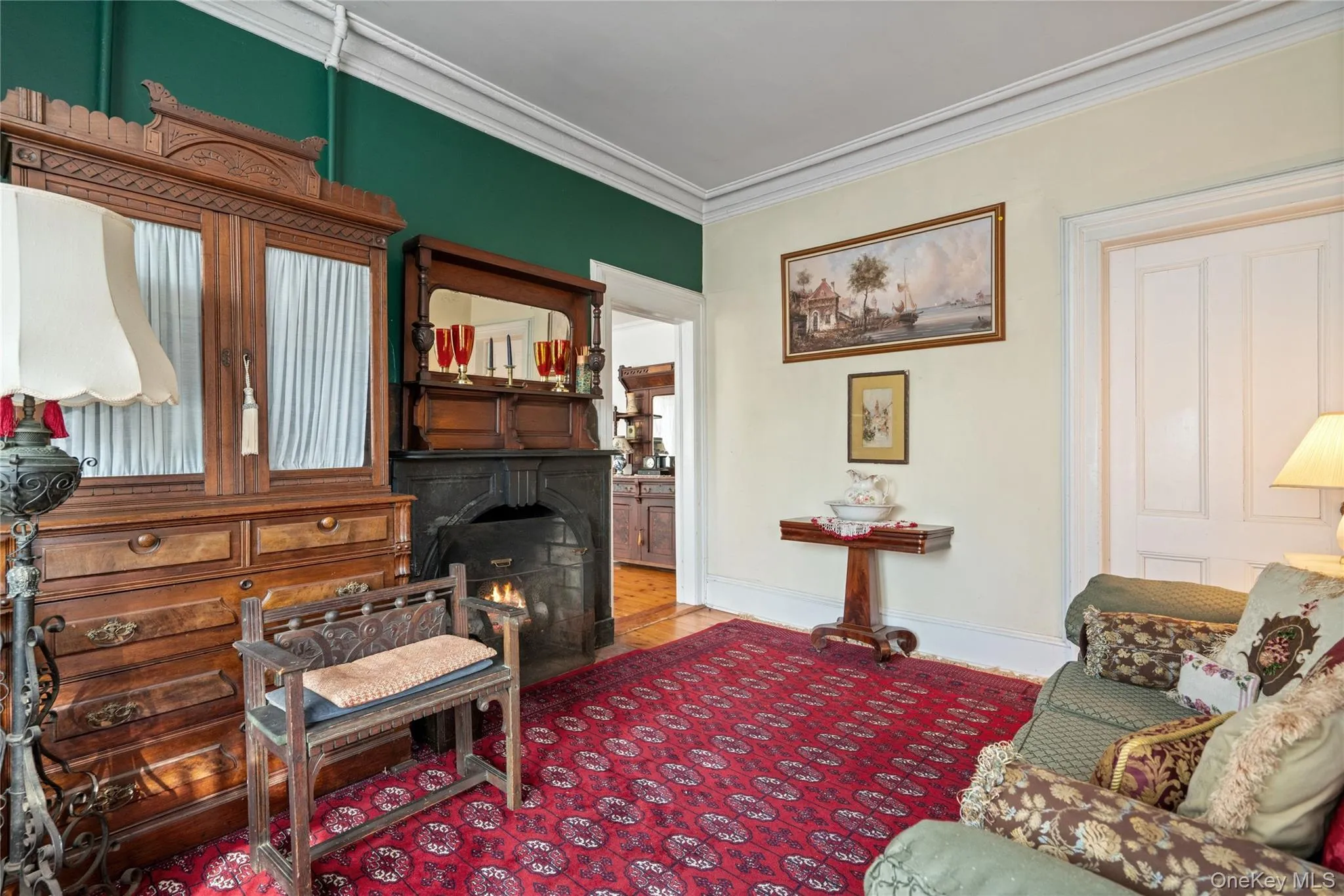 Living room featuring crown molding and a fireplace with flush hearth Living room featuring crown molding and a fireplace with flush hearth