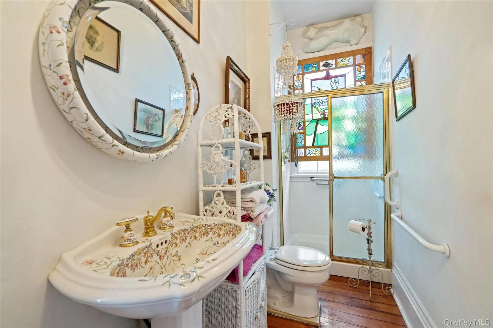 Full bathroom featuring a shower stall and hardwood / wood-style flooring Full bathroom featuring a shower stall and hardwood / wood-style flooring