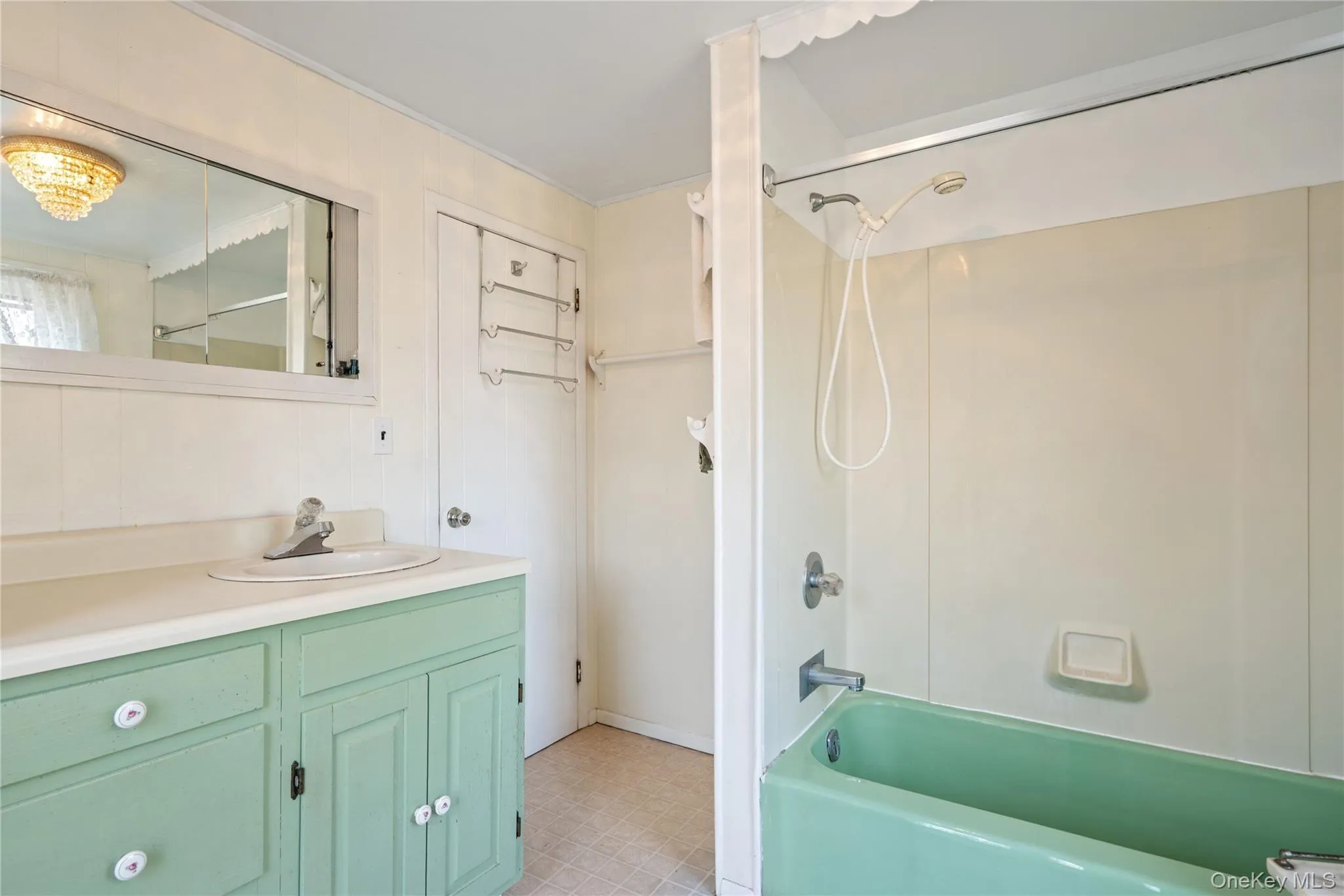 Bathroom featuring vanity, shower / bathtub combination, and light flooring Bathroom featuring vanity, shower / bathtub combination, and light flooring