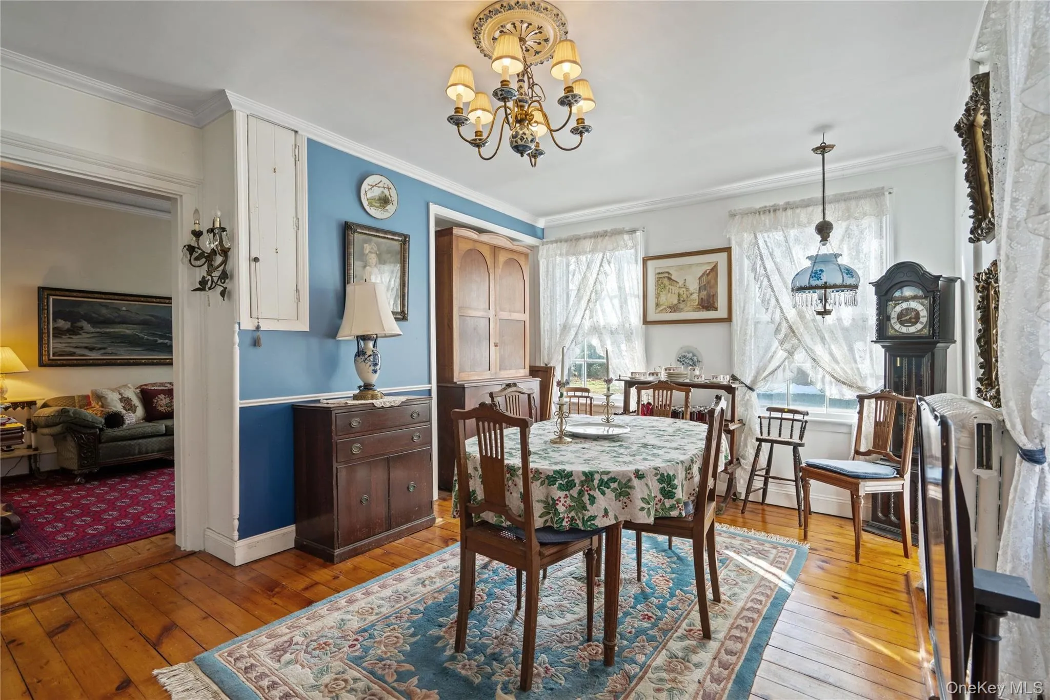 Dining area with a chandelier, hardwood / wood-style flooring, and crown molding Dining area with a chandelier, hardwood / wood-style flooring, and crown molding
