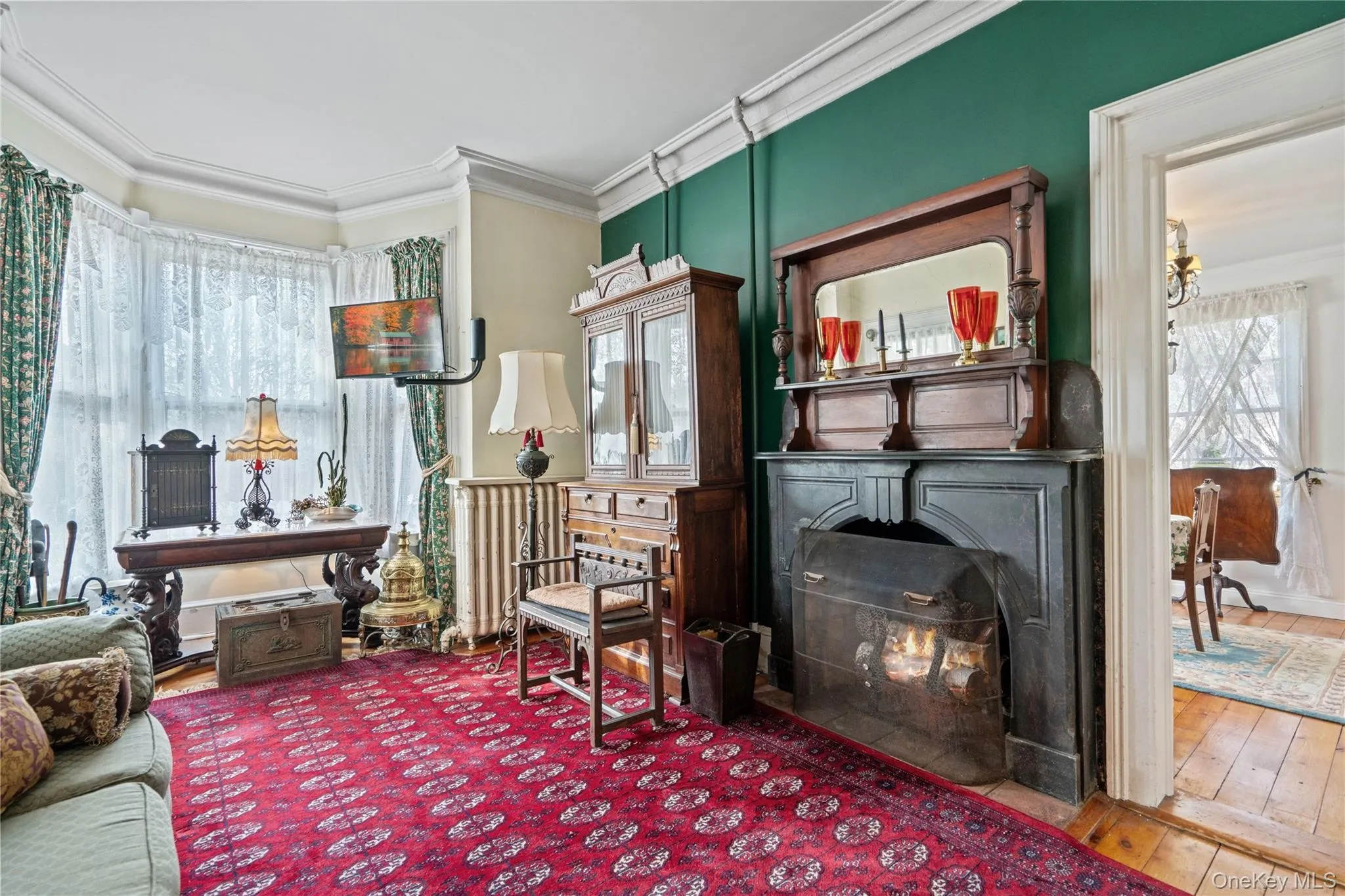 Living area featuring ornamental molding and hardwood / wood-style flooring Living area featuring ornamental molding and hardwood / wood-style flooring