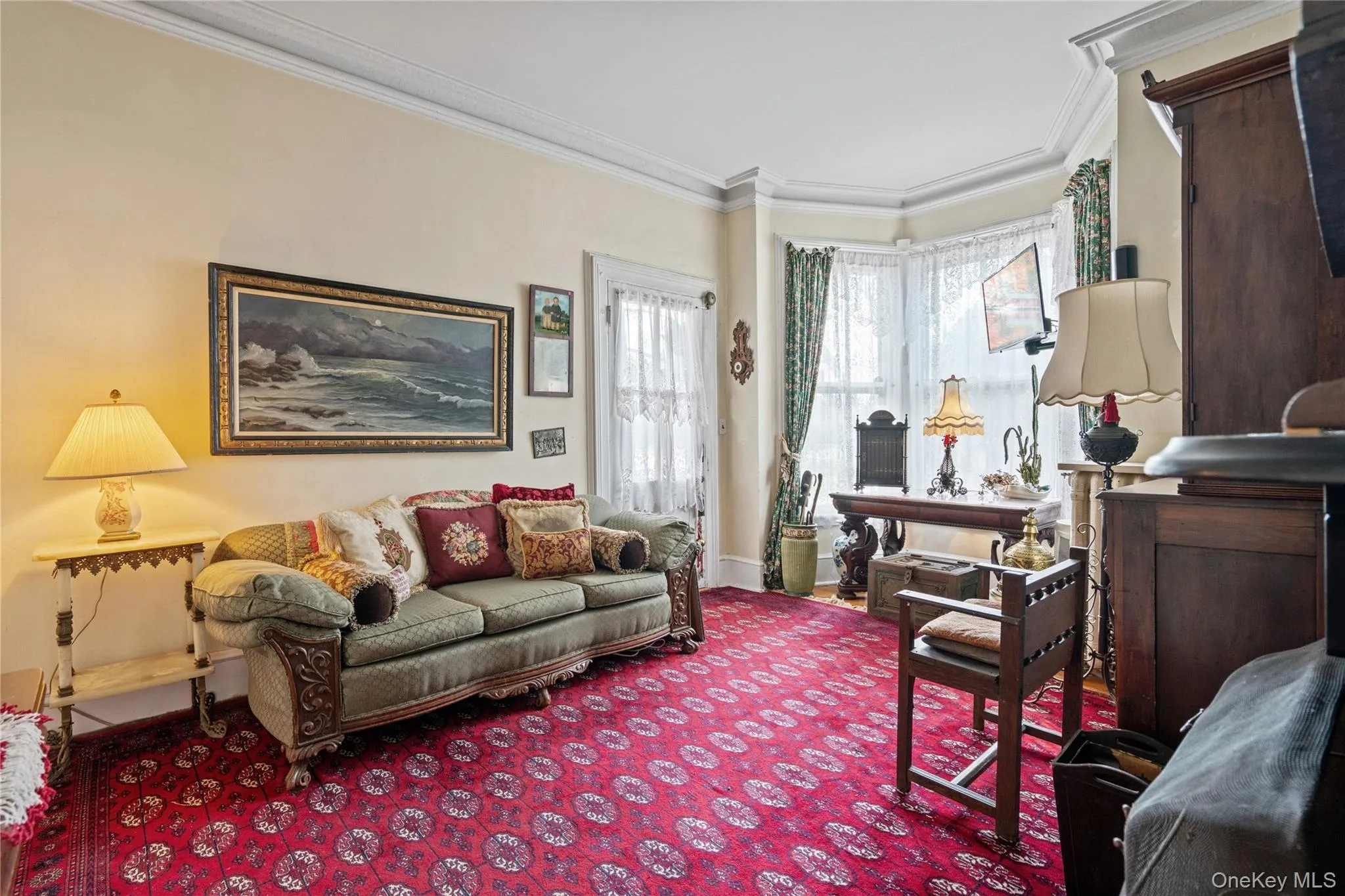 Living area with ornamental molding and carpet Living area with ornamental molding and carpet