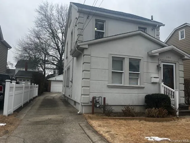 View of property exterior featuring stucco siding, an outbuilding, and a detached garage View of property exterior featuring stucco siding, an outbuilding, and a detached garage