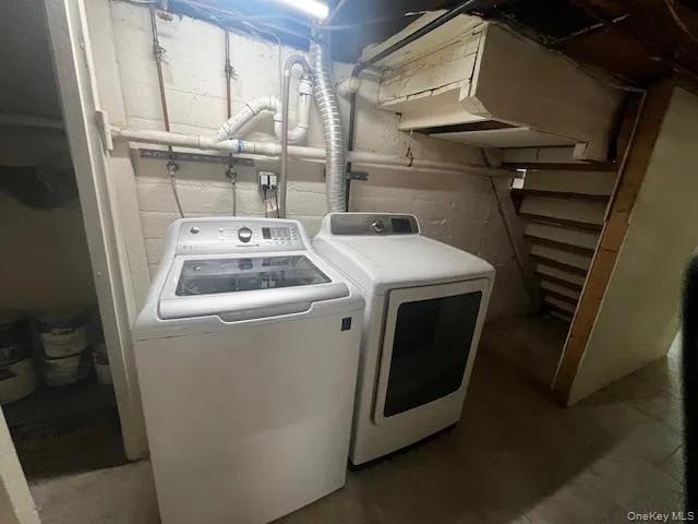 Laundry room with separate washer and dryer and concrete flooring Laundry room with separate washer and dryer and concrete flooring