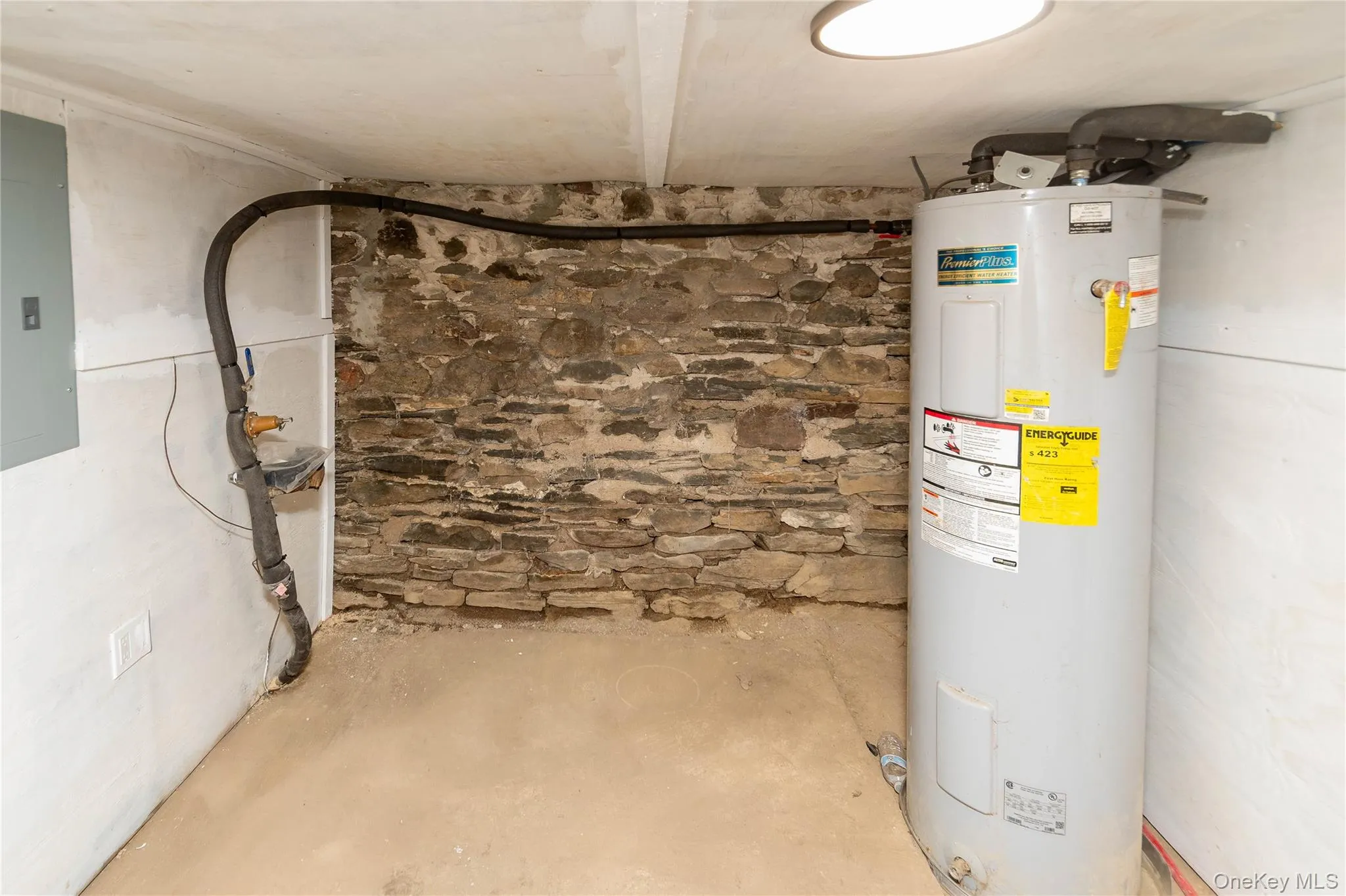 Utility room featuring water heater and electric panel Utility room featuring water heater and electric panel