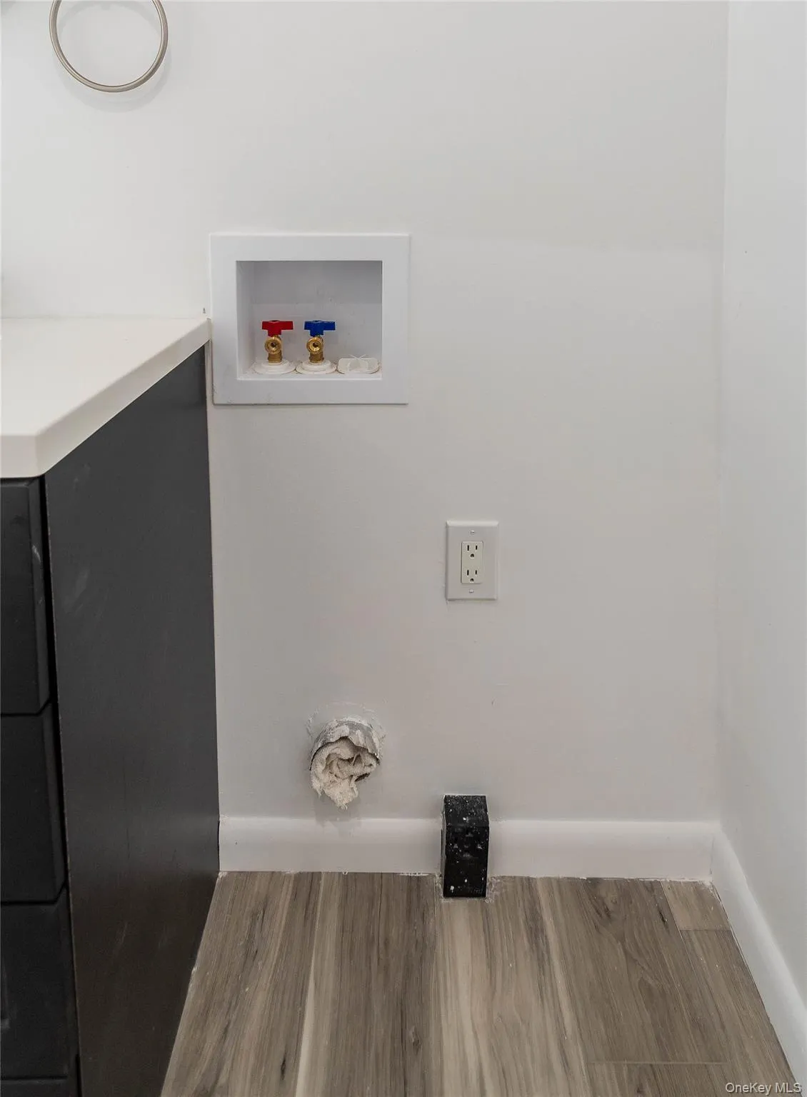 Laundry room with wood finished floors and hookup for a washing machine Laundry room with wood finished floors and hookup for a washing machine