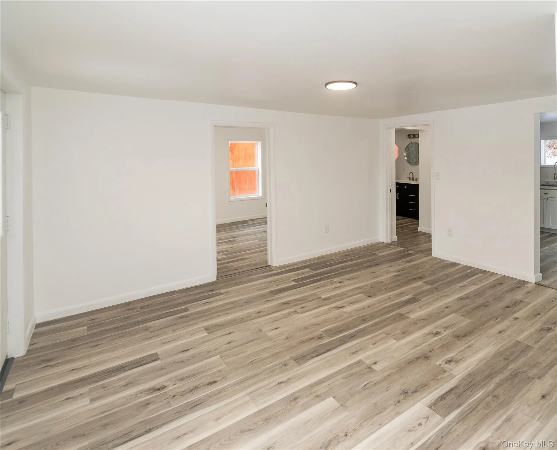 Spare room featuring light wood finished floors and baseboards Spare room featuring light wood finished floors and baseboards
