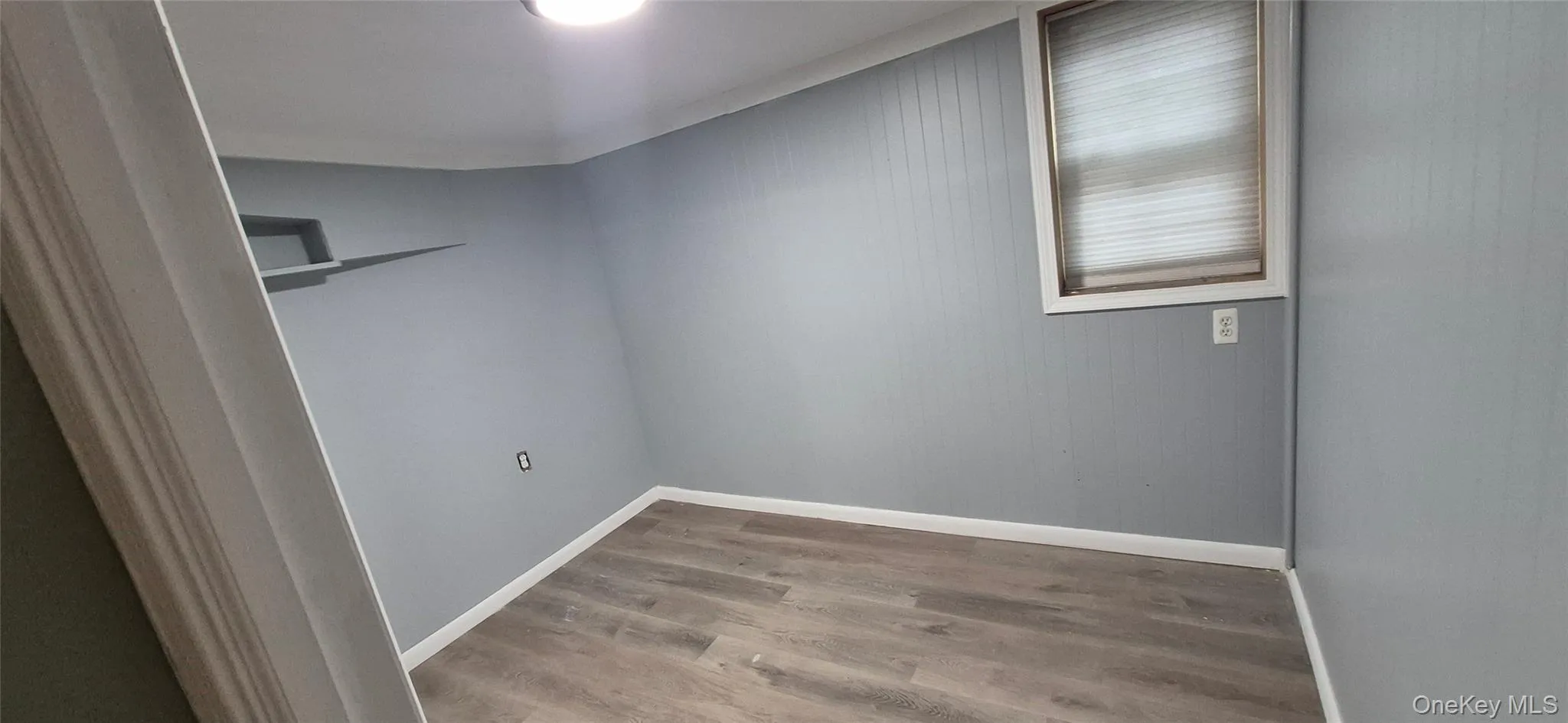 Unfurnished room featuring light wood-style floors and baseboards Unfurnished room featuring light wood-style floors and baseboards