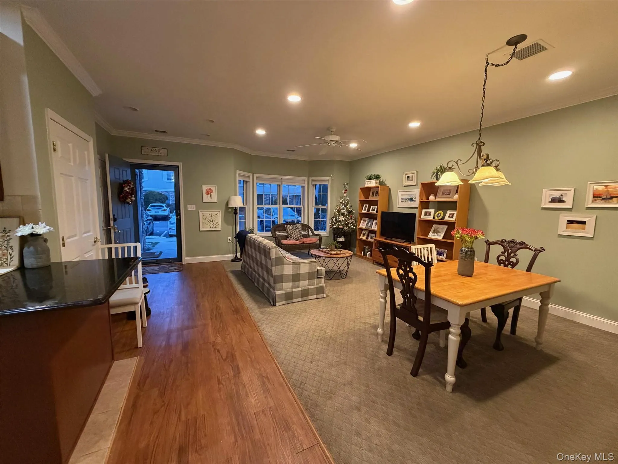 Dining space with crown molding, light wood finished floors, recessed lighting, and a ceiling fan Dining space with crown molding, light wood finished floors, recessed lighting, and a ceiling fan