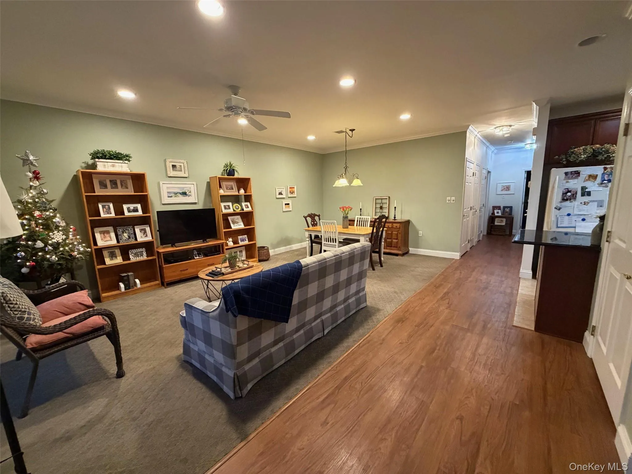 Living area featuring recessed lighting, crown molding, ceiling fan, and light wood-type flooring Living area featuring recessed lighting, crown molding, ceiling fan, and light wood-type flooring