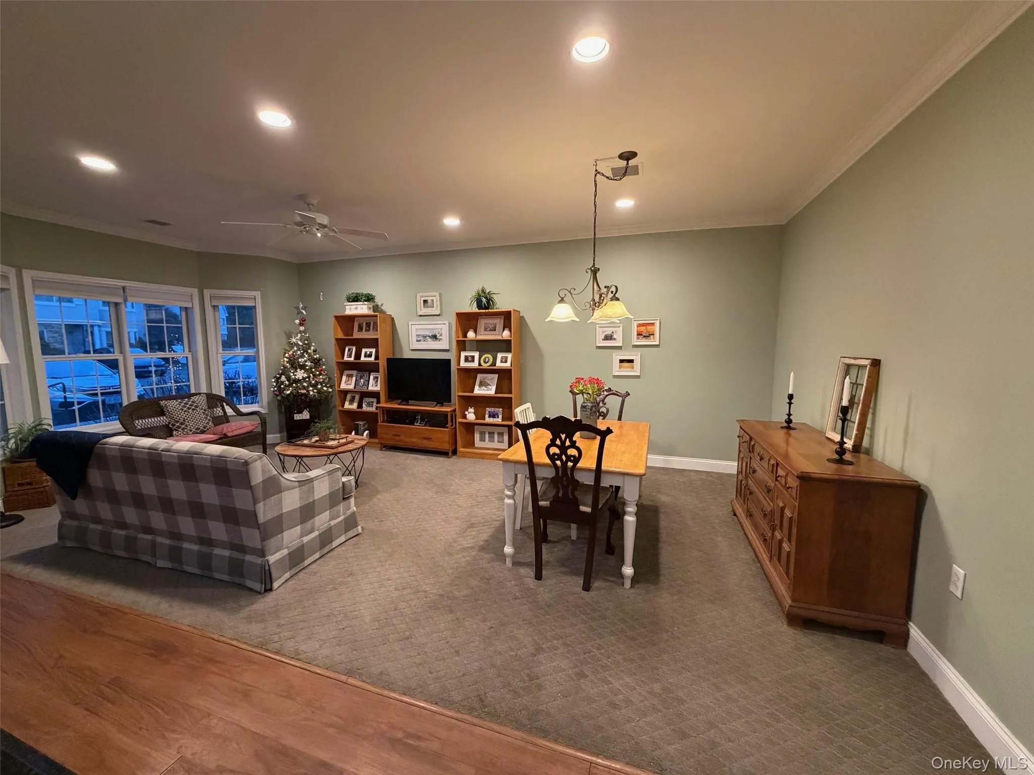 Living room featuring ornamental molding, recessed lighting, and a ceiling fan Living room featuring ornamental molding, recessed lighting, and a ceiling fan