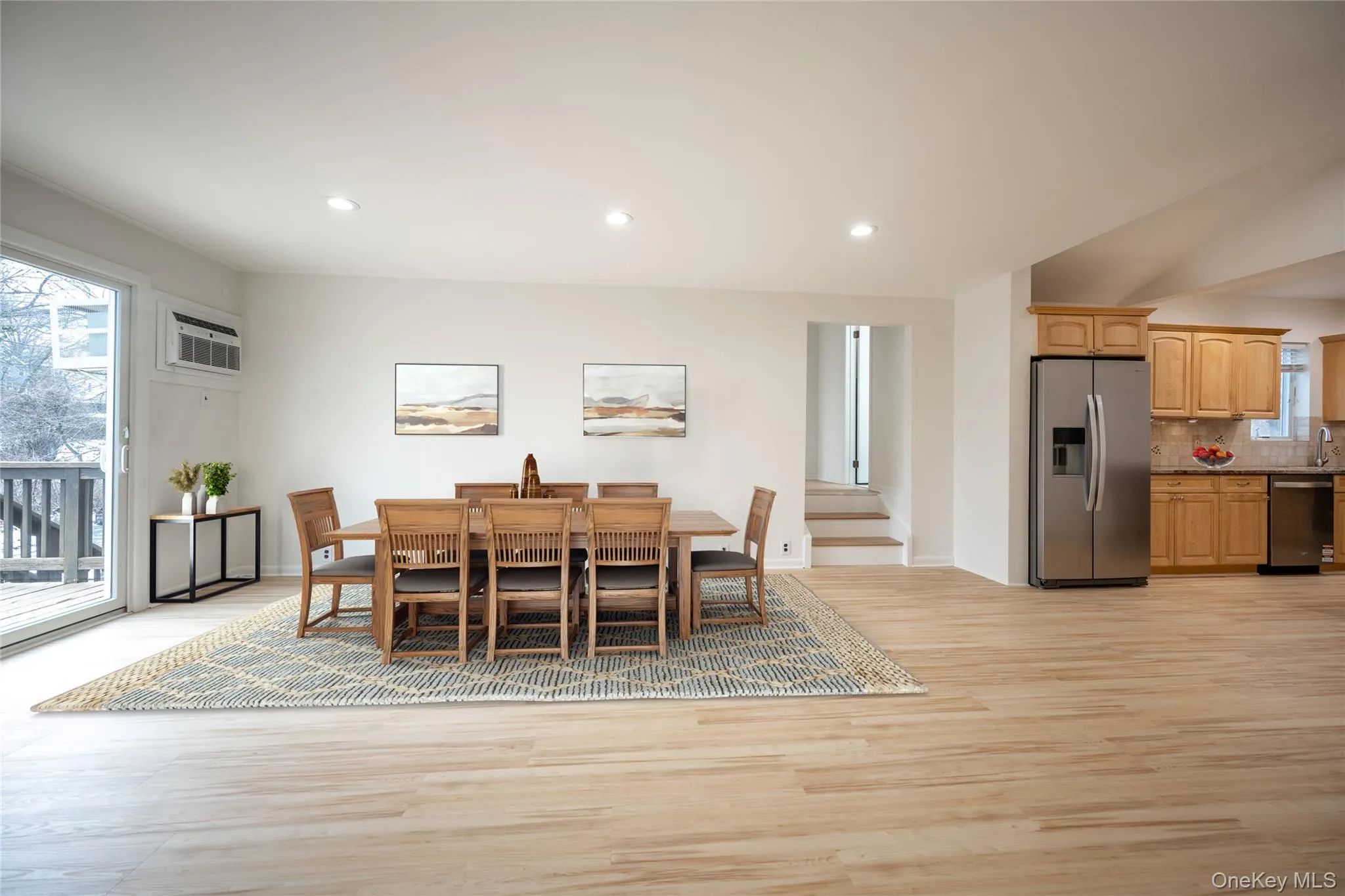 Family Room/Dining showing three steps leading up to the Primary Suite. Family Room/Dining showing three steps leading up to the Primary Suite.