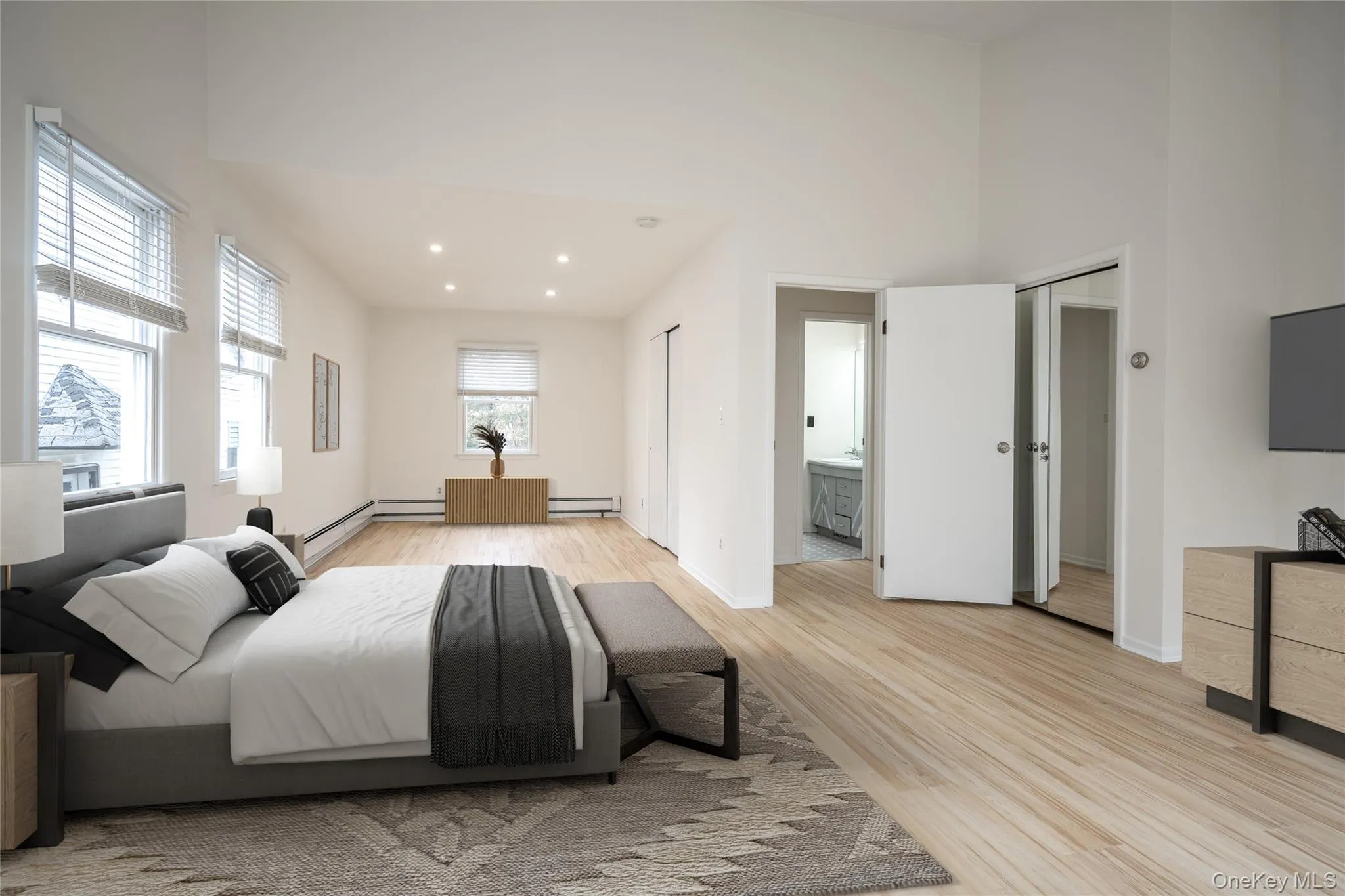 An expansive and versatile primary suite with a private balcony and lovely views, easily accommodating a home office or sitting area. Virtually Staged An expansive and versatile primary suite with a private balcony and lovely views, easily accommodating a home office or sitting area. Virtually Staged