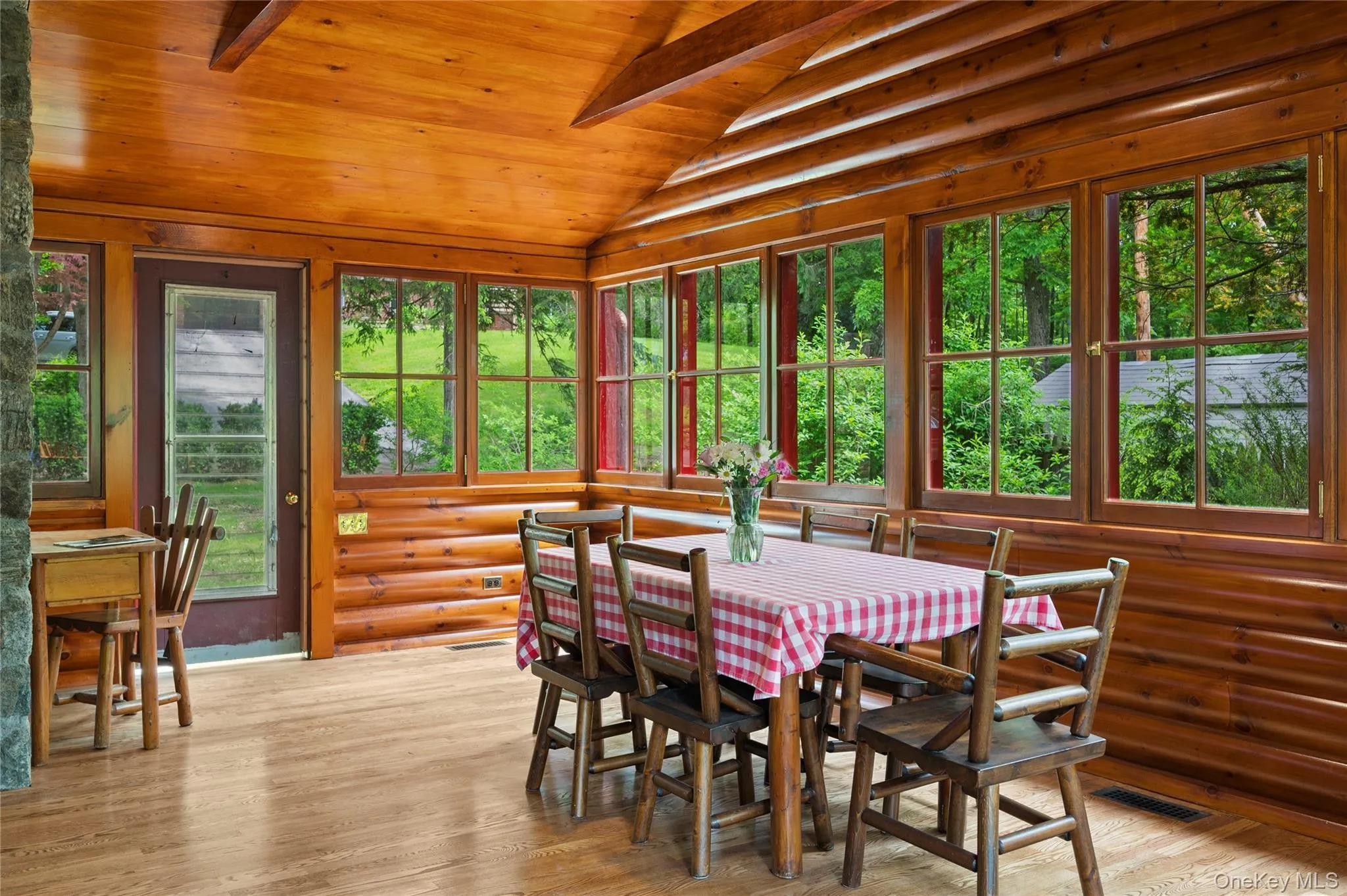 Dining room featuring vaulted ceiling, healthy amount of natural light, wood finished floors, and wooden ceiling Dining room featuring vaulted ceiling, healthy amount of natural light, wood finished floors, and wooden ceiling