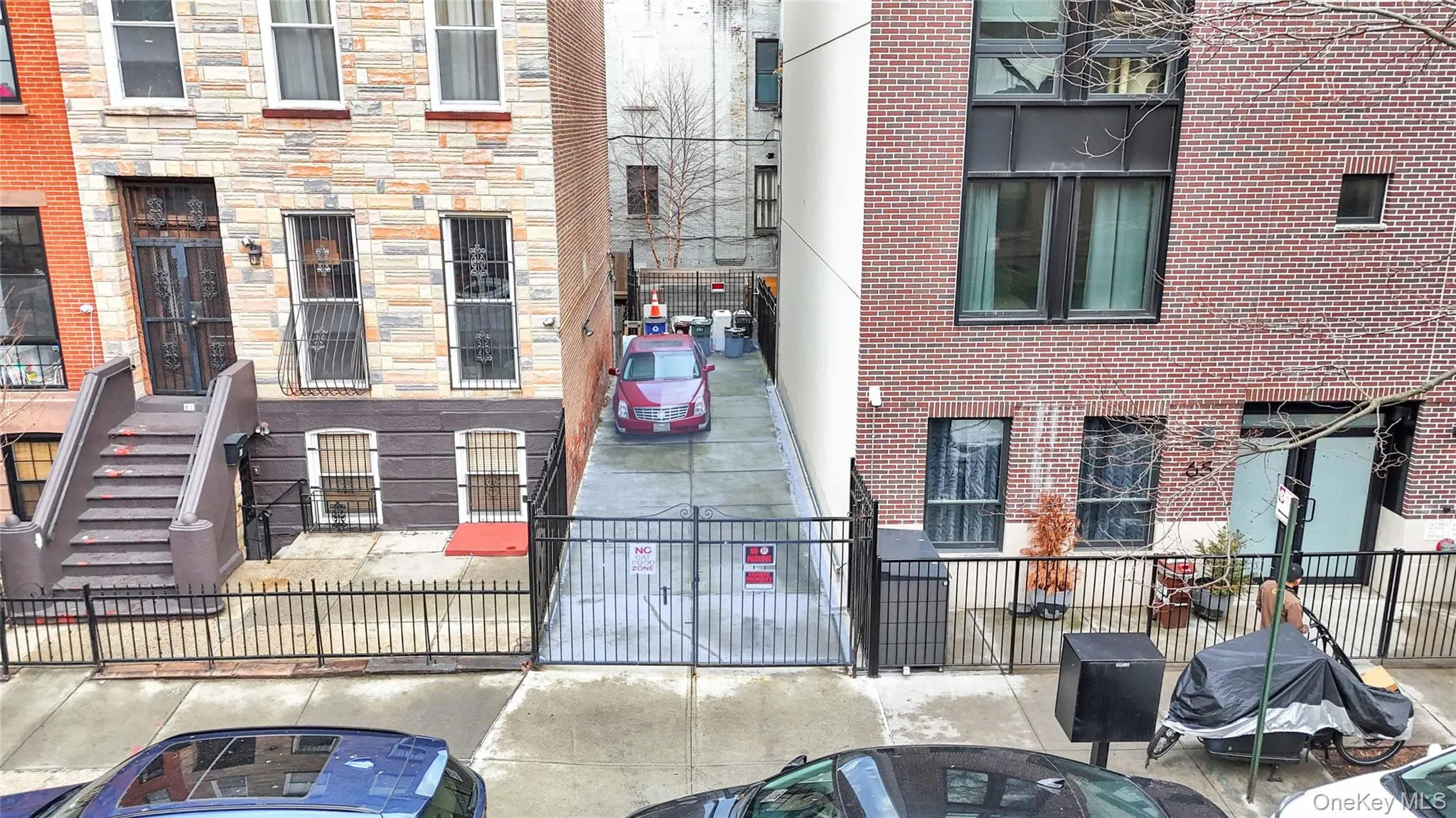 View of building exterior featuring a fenced front yard View of building exterior featuring a fenced front yard
