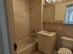 Bathroom featuring vanity and bathing tub / shower combination Bathroom featuring vanity and bathing tub / shower combination
