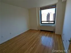 Spare room featuring dark wood-style floors and baseboards Spare room featuring dark wood-style floors and baseboards