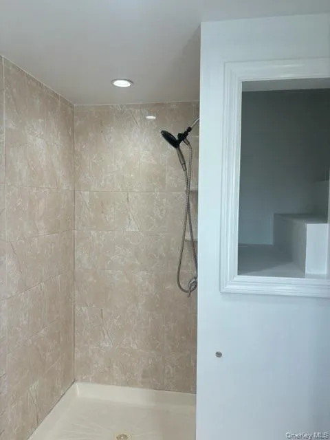 Bathroom with a shower stall and recessed lighting Bathroom with a shower stall and recessed lighting