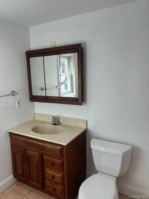 Bathroom with vanity and light tile patterned floors Bathroom with vanity and light tile patterned floors
