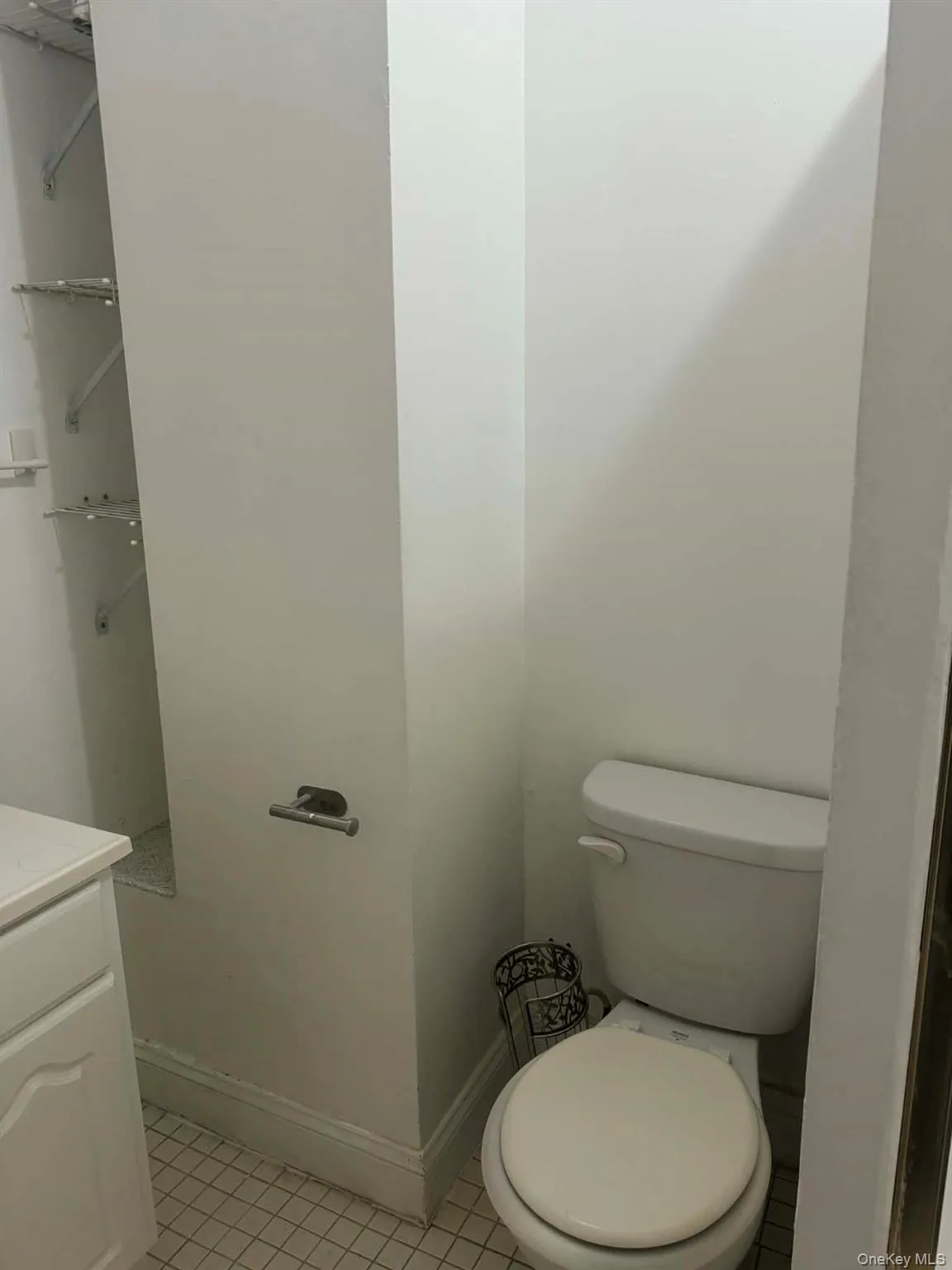 Bathroom featuring vanity and light tile patterned flooring Bathroom featuring vanity and light tile patterned flooring