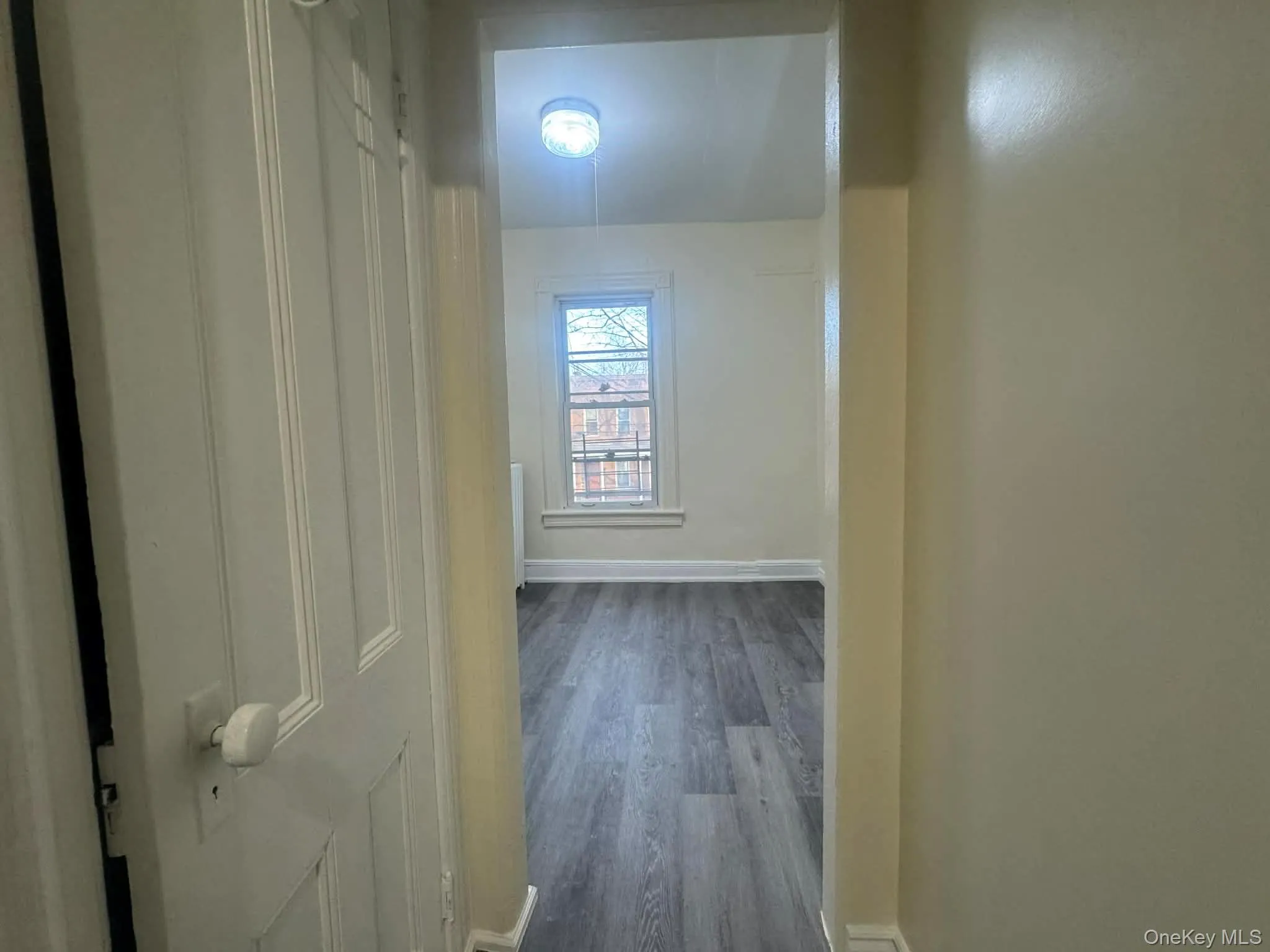 Hall with dark wood finished floors and baseboards Hall with dark wood finished floors and baseboards