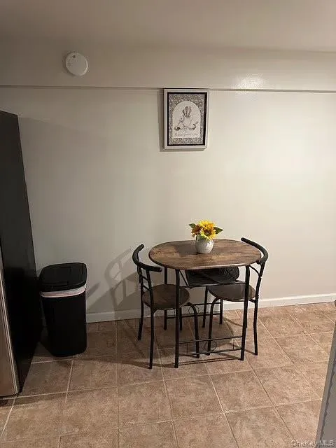 Dining room with baseboards and light tile patterned floors Dining room with baseboards and light tile patterned floors