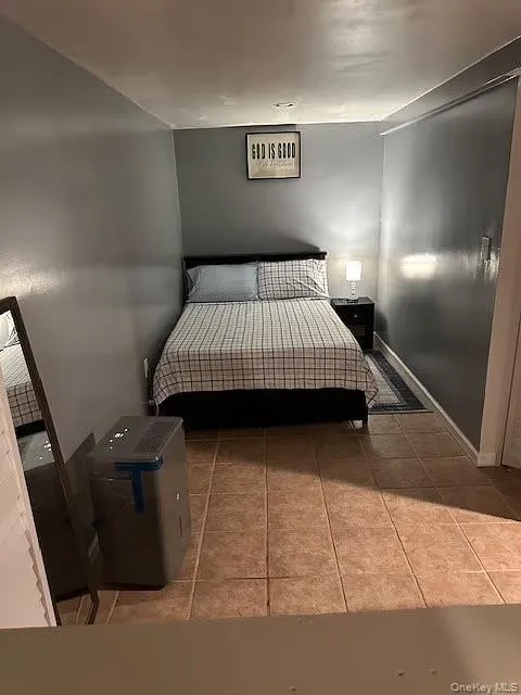 Bedroom with light tile patterned flooring Bedroom with light tile patterned flooring