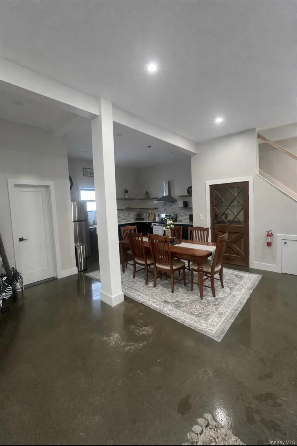 Dining room with finished concrete floors and baseboards Dining room with finished concrete floors and baseboards