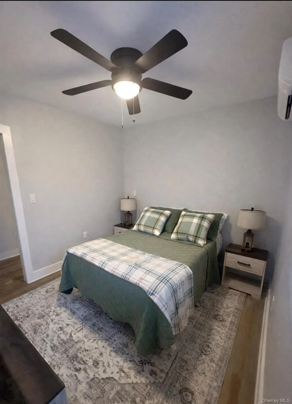 Bedroom featuring wood finished floors and a ceiling fan Bedroom featuring wood finished floors and a ceiling fan