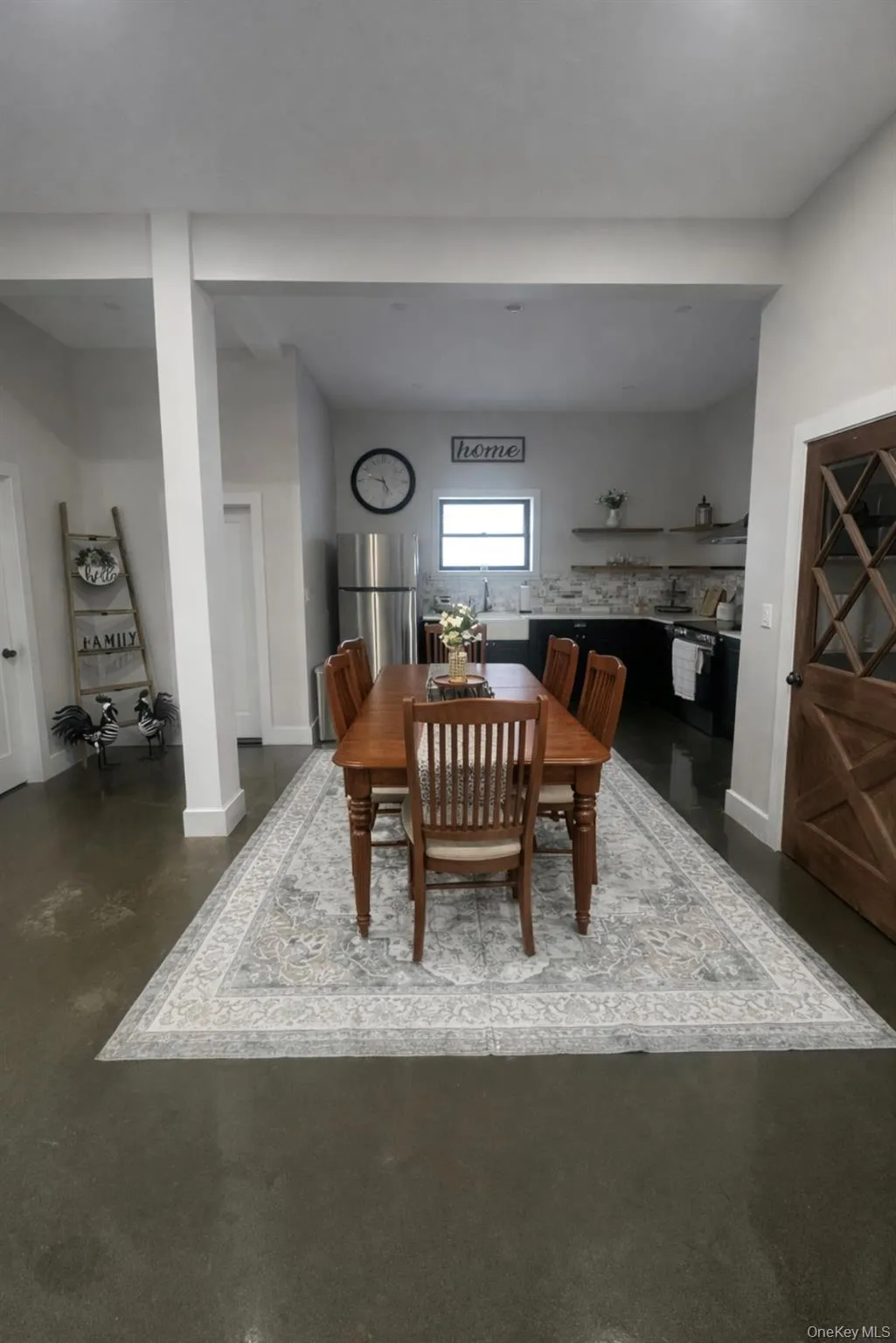 Dining room with finished concrete floors and baseboards Dining room with finished concrete floors and baseboards