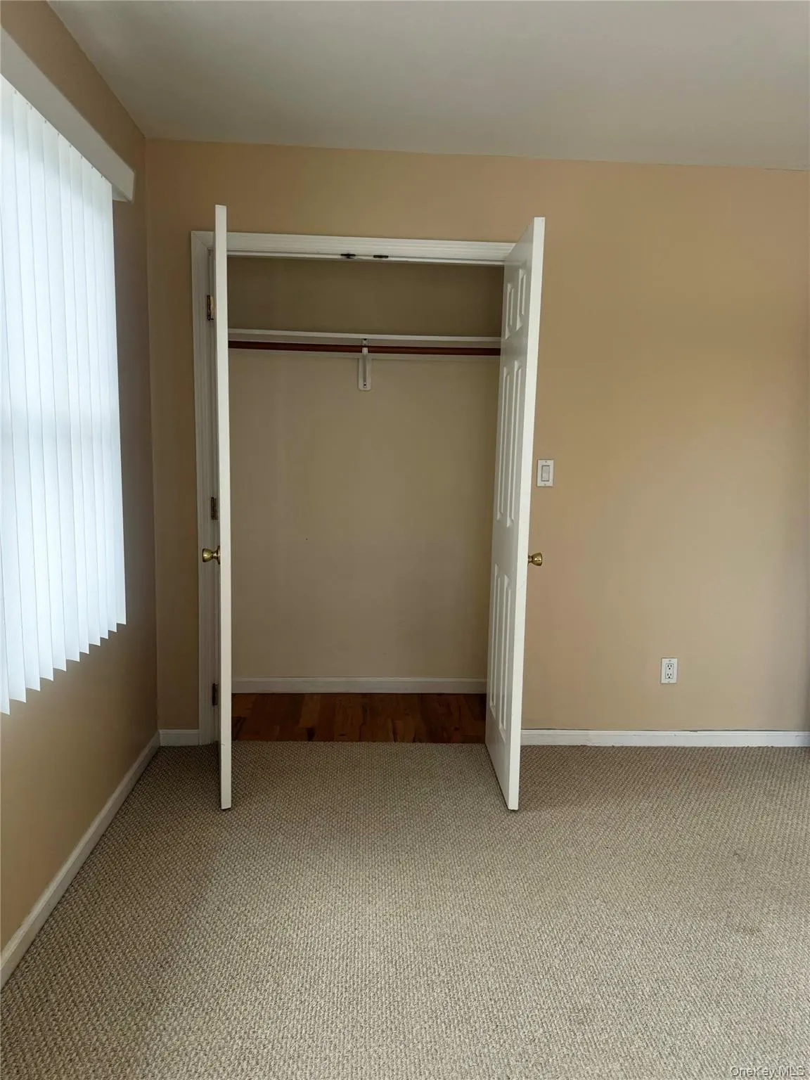 Unfurnished bedroom with carpet floors and a closet Unfurnished bedroom with carpet floors and a closet