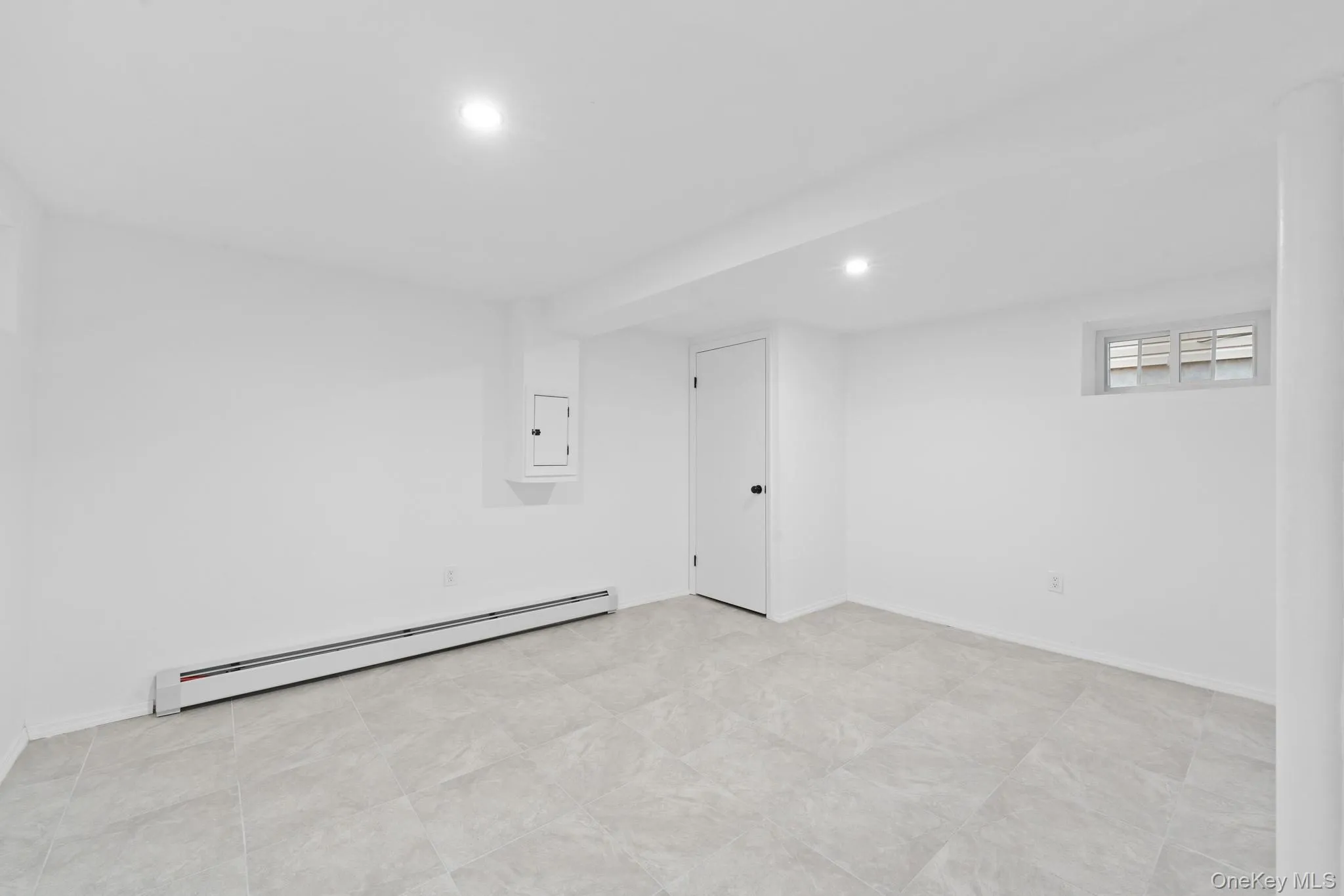 Basement featuring a baseboard radiator and recessed lighting Basement featuring a baseboard radiator and recessed lighting