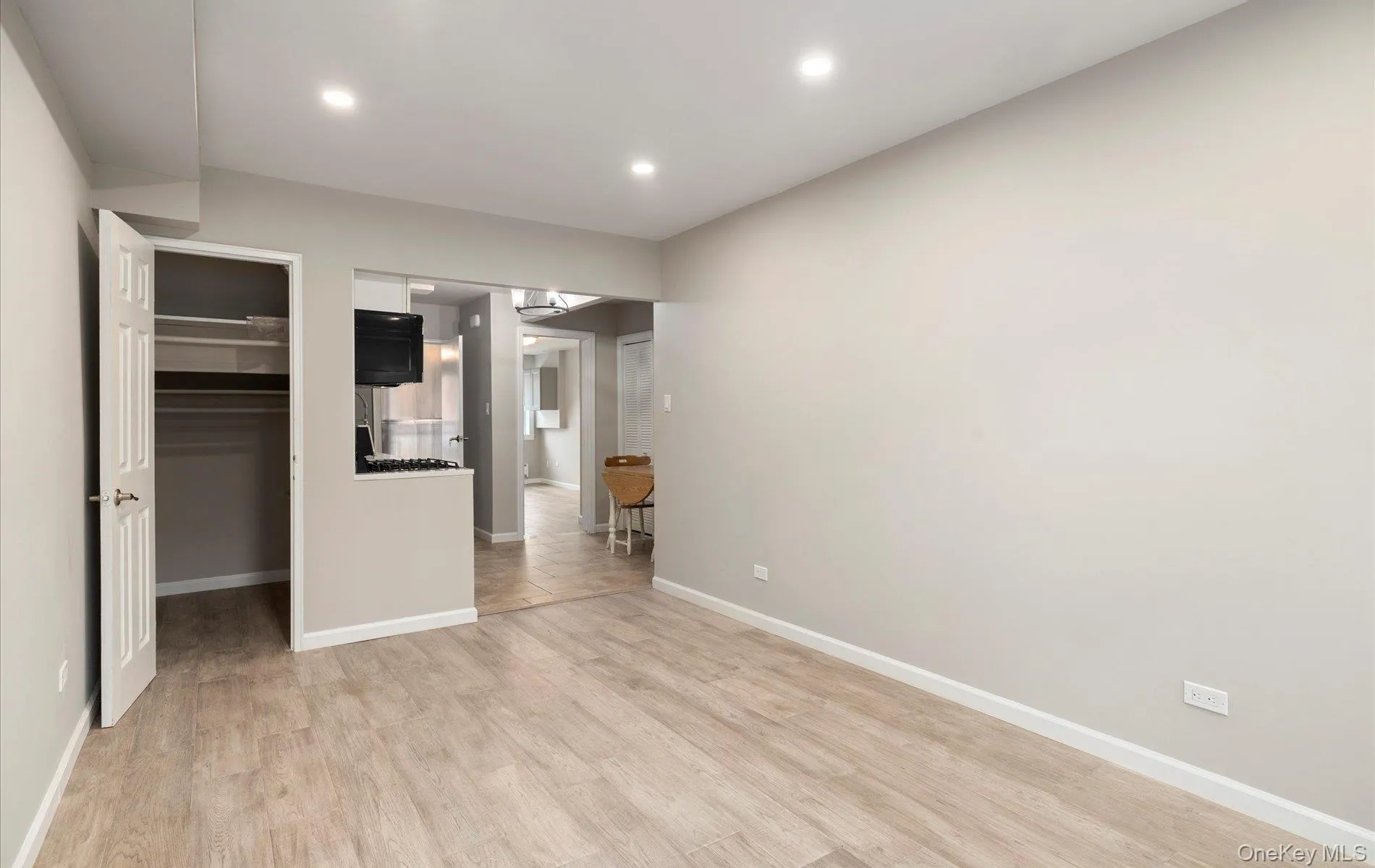 Unfurnished bedroom with a spacious closet, light wood-type flooring, and recessed lighting Unfurnished bedroom with a spacious closet, light wood-type flooring, and recessed lighting