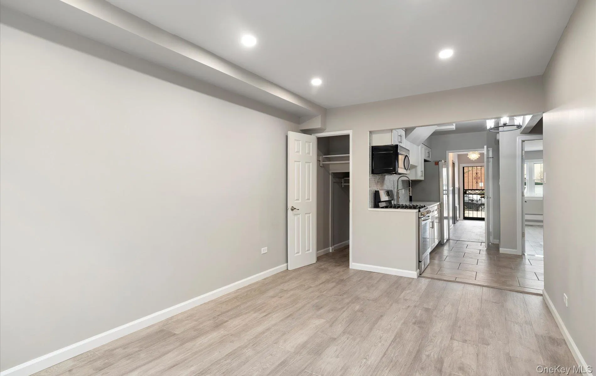 Kitchen featuring appliances with stainless steel finishes, light wood-type flooring, white cabinetry, and recessed lighting Kitchen featuring appliances with stainless steel finishes, light wood-type flooring, white cabinetry, and recessed lighting