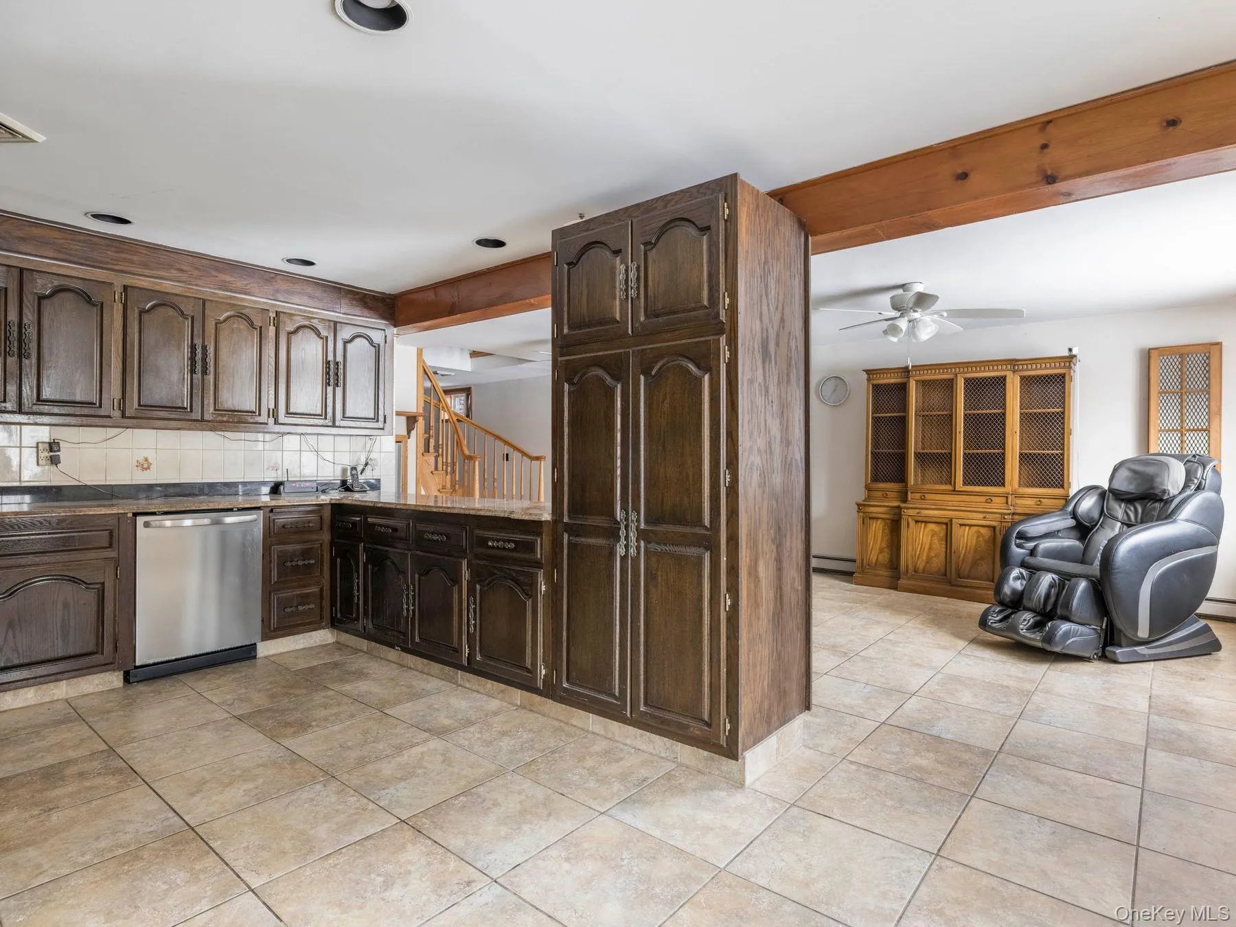 Kitchen featuring dark brown cabinets, dishwasher, light tile patterned flooring, dark countertops, and a ceiling fan Kitchen featuring dark brown cabinets, dishwasher, light tile patterned flooring, dark countertops, and a ceiling fan