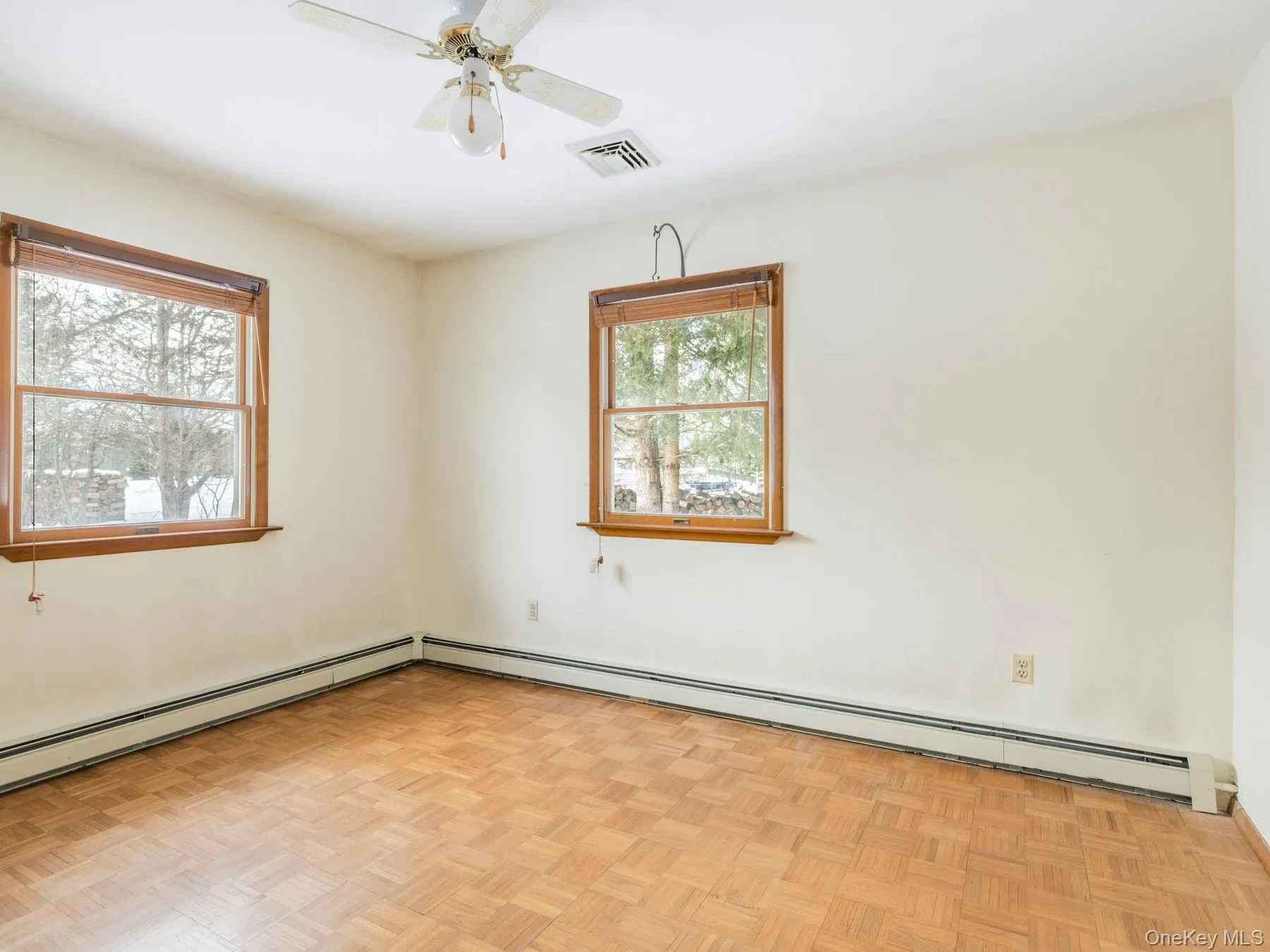 Unfurnished room featuring baseboard heating and ceiling fan Unfurnished room featuring baseboard heating and ceiling fan