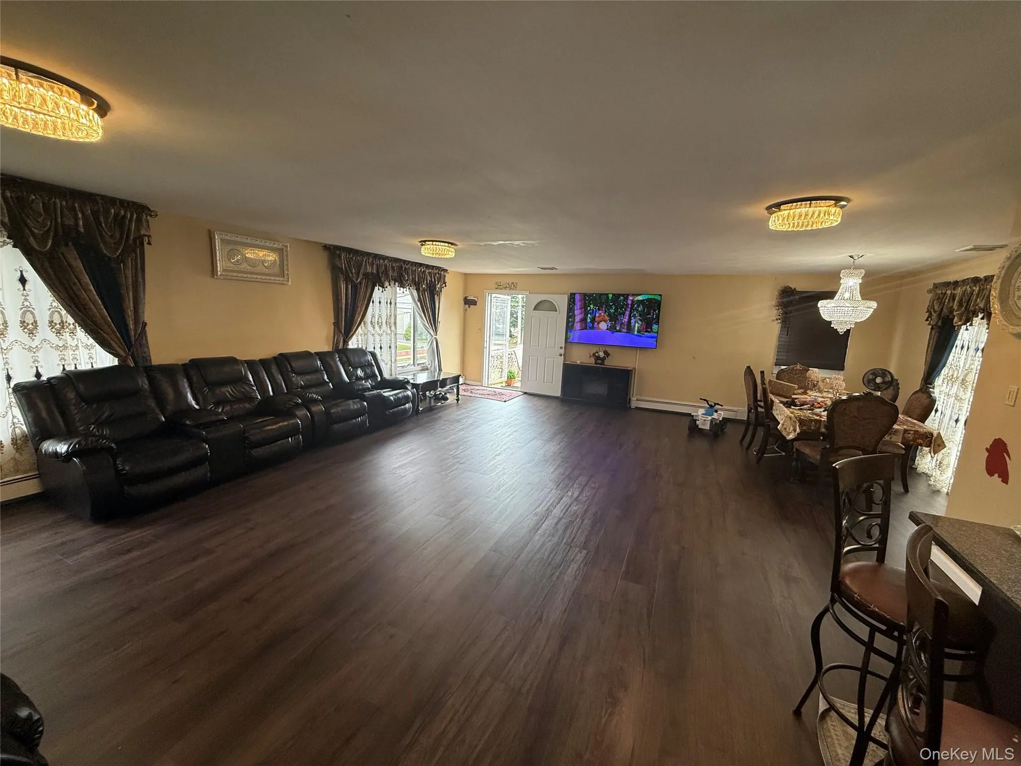 Living area featuring wood finished floors and a chandelier Living area featuring wood finished floors and a chandelier