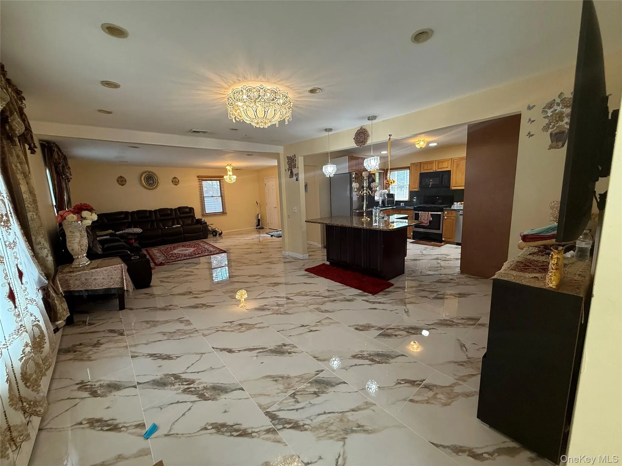 Living room with recessed lighting and a chandelier Living room with recessed lighting and a chandelier