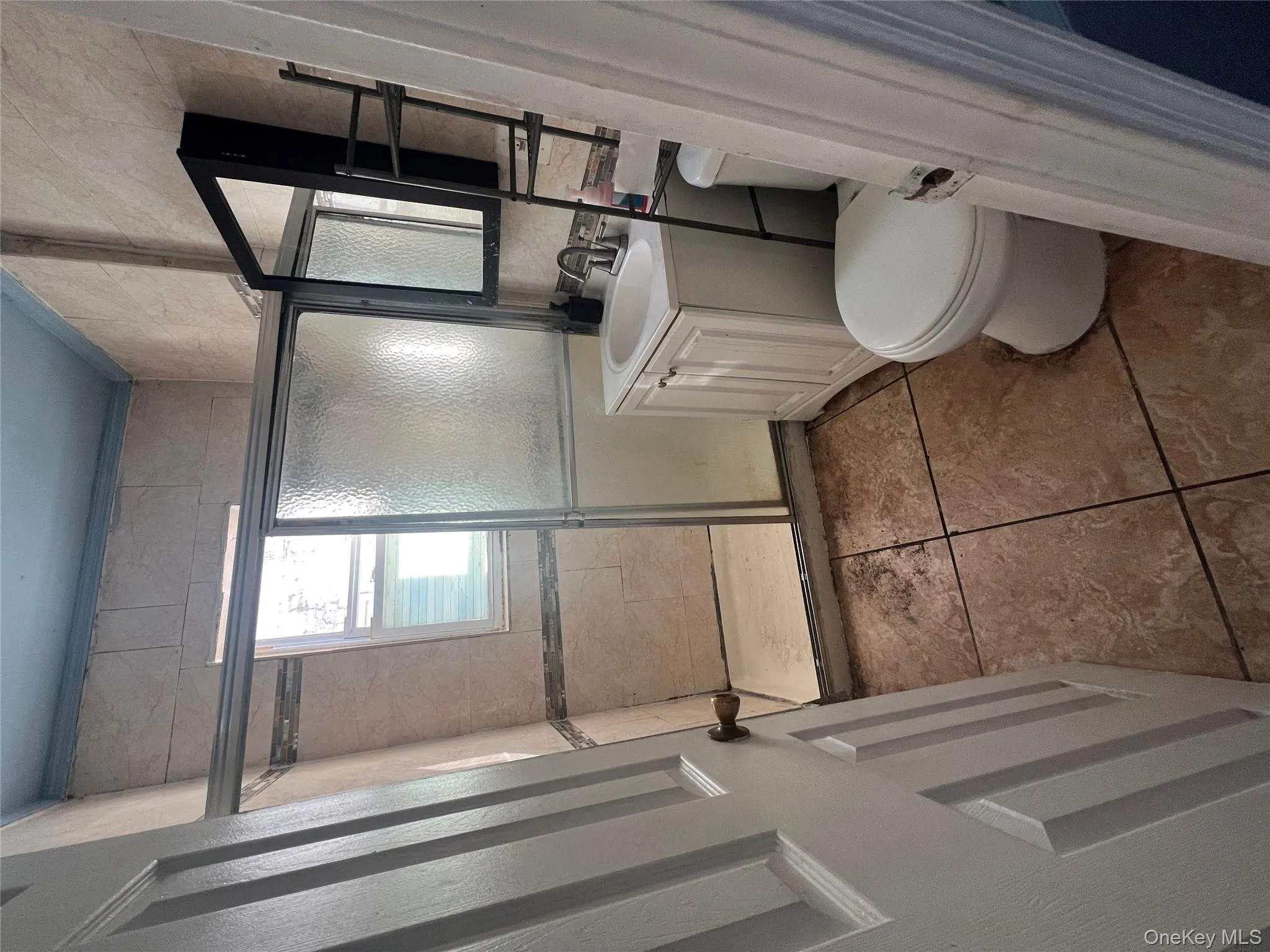 Full bathroom with vanity, a shower stall, and tile patterned floors Full bathroom with vanity, a shower stall, and tile patterned floors