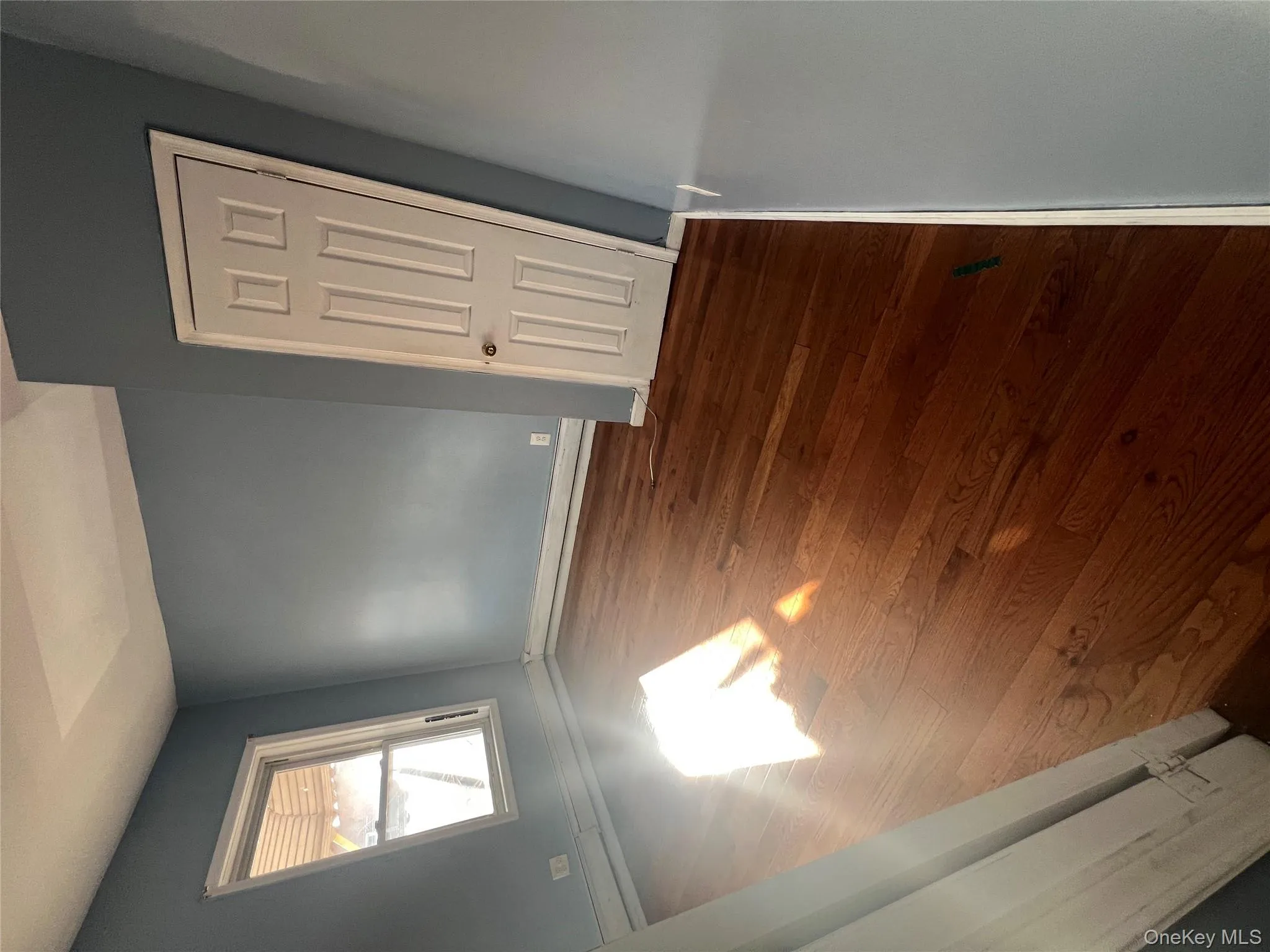 Unfurnished bedroom with dark wood finished floors and a baseboard radiator Unfurnished bedroom with dark wood finished floors and a baseboard radiator