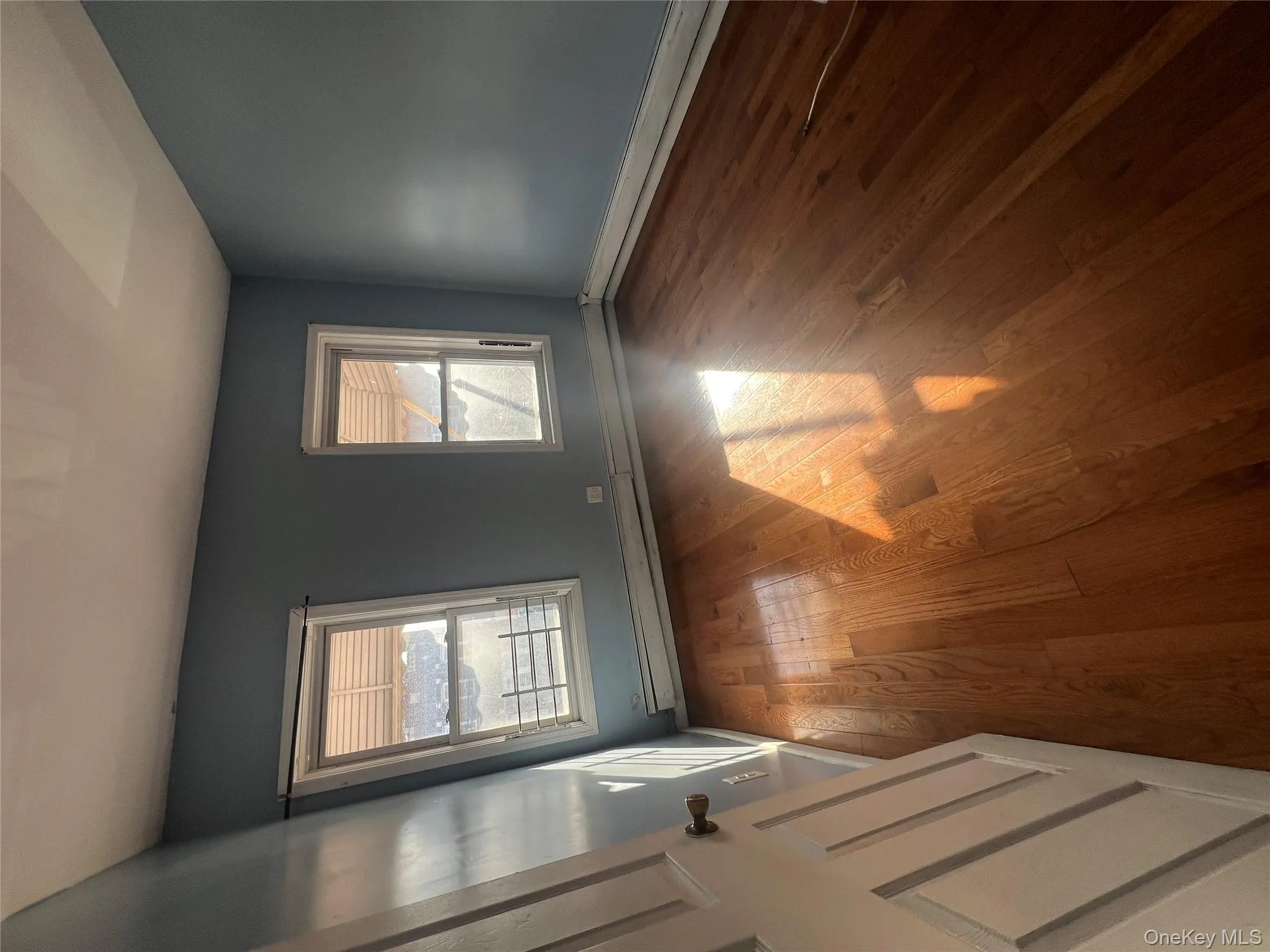 Spare room featuring hardwood / wood-style floors and a baseboard radiator Spare room featuring hardwood / wood-style floors and a baseboard radiator
