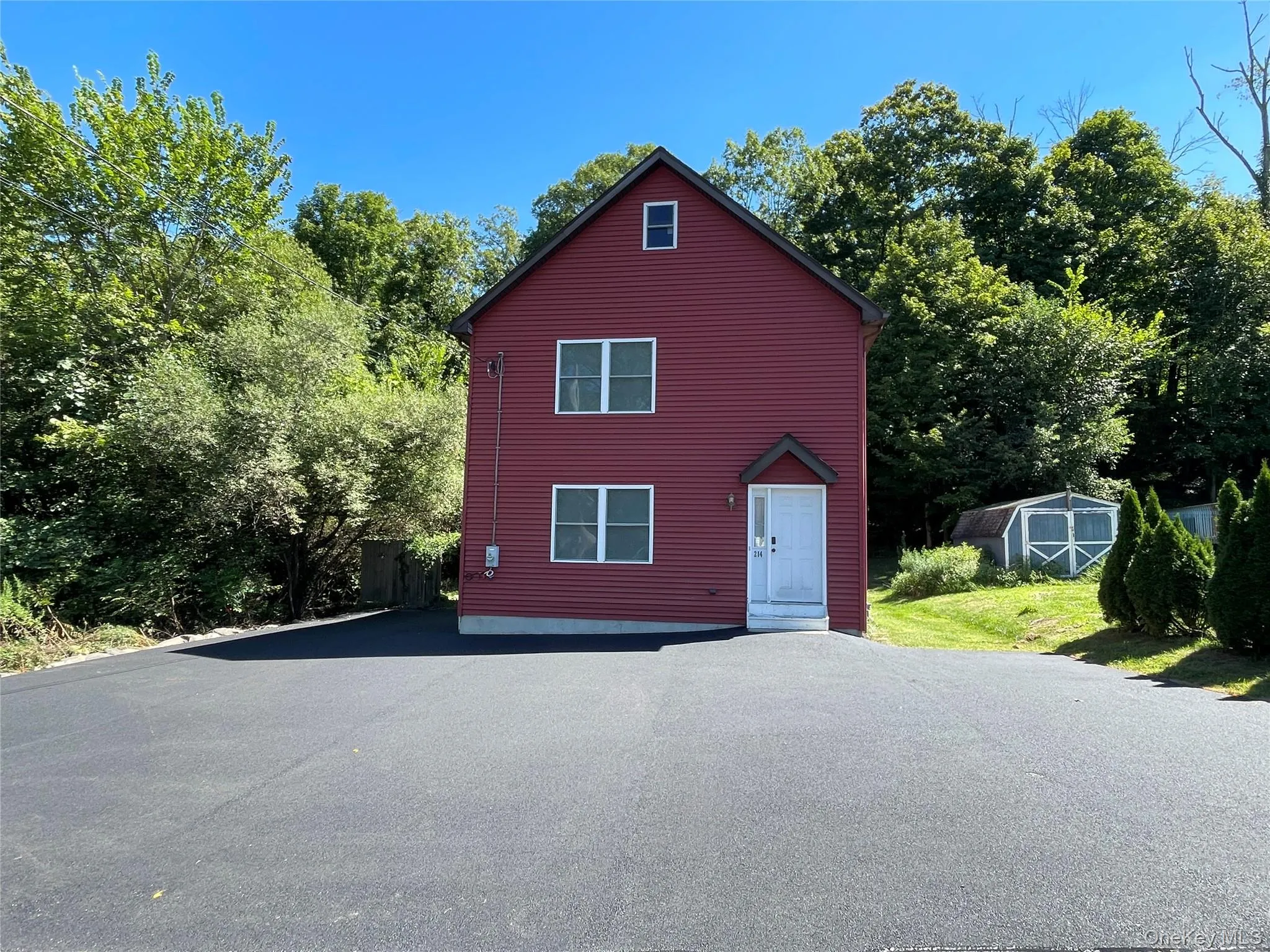 View of side of home with a storage shed and driveway View of side of home with a storage shed and driveway