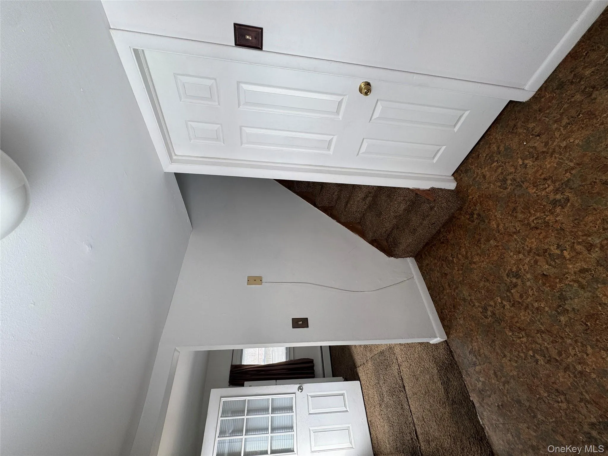 Basement featuring dark colored carpet and stairway Basement featuring dark colored carpet and stairway