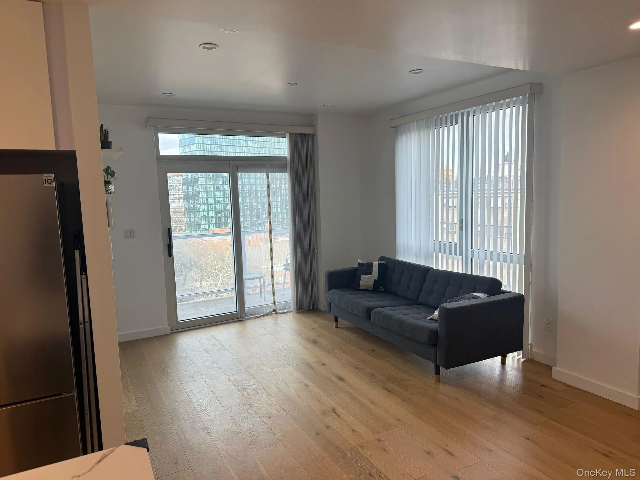 Living area featuring light wood-style flooring and recessed lighting Living area featuring light wood-style flooring and recessed lighting